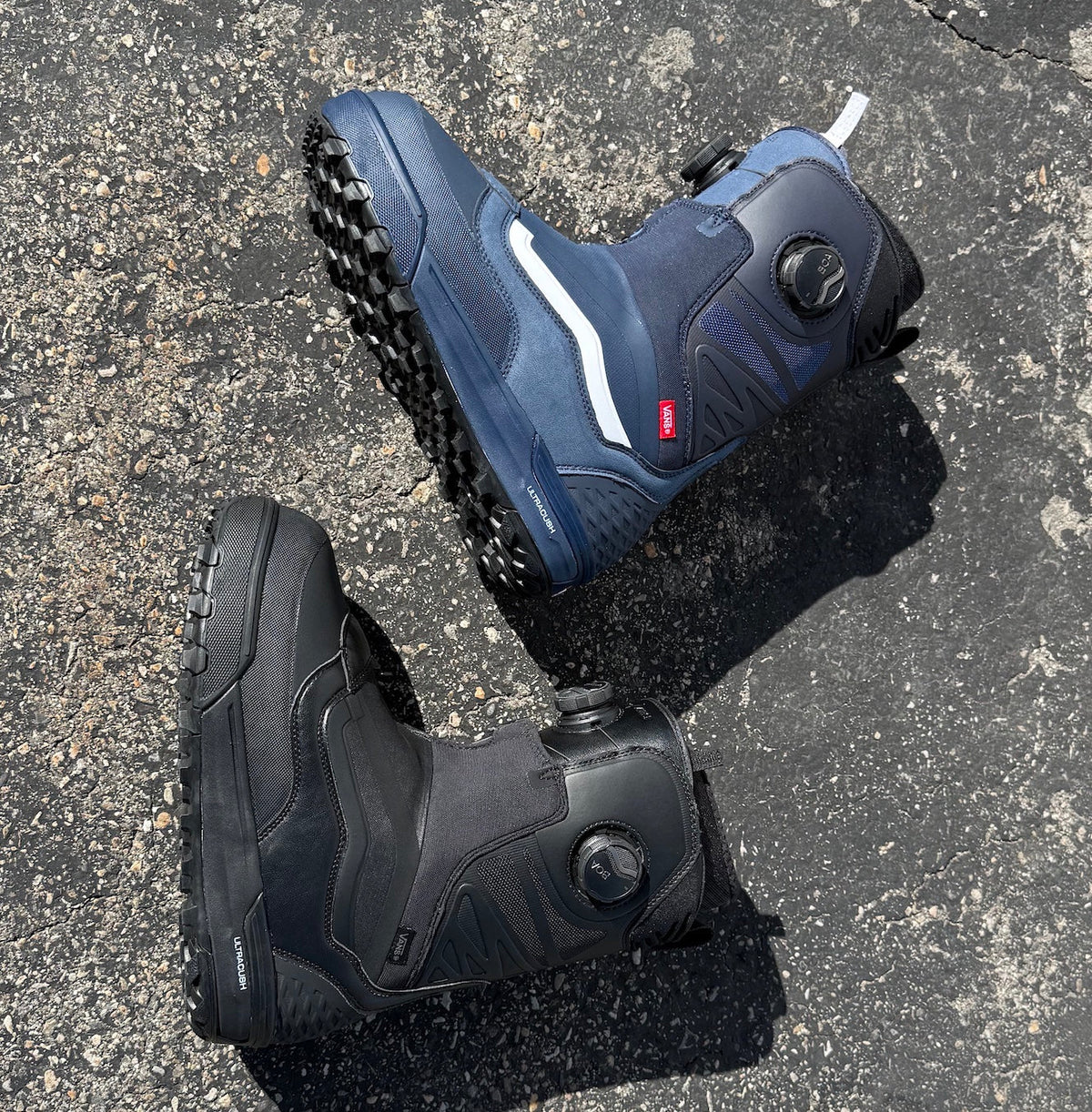 vans verse snowboard boots in blue and black on black asphalt background