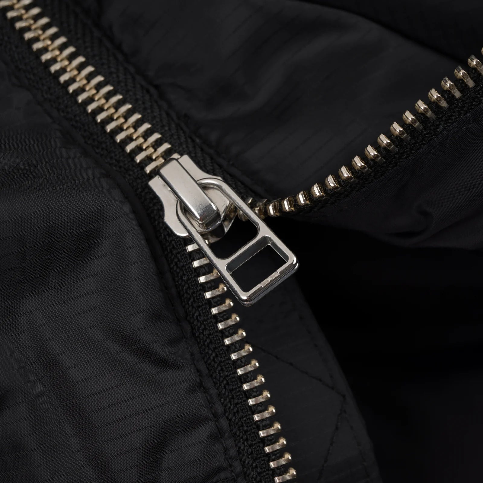 Black Souvenir Everyday Puffer 2026 jacket with front zipper and quilted design, stylish and warm outerwear for cold weather.