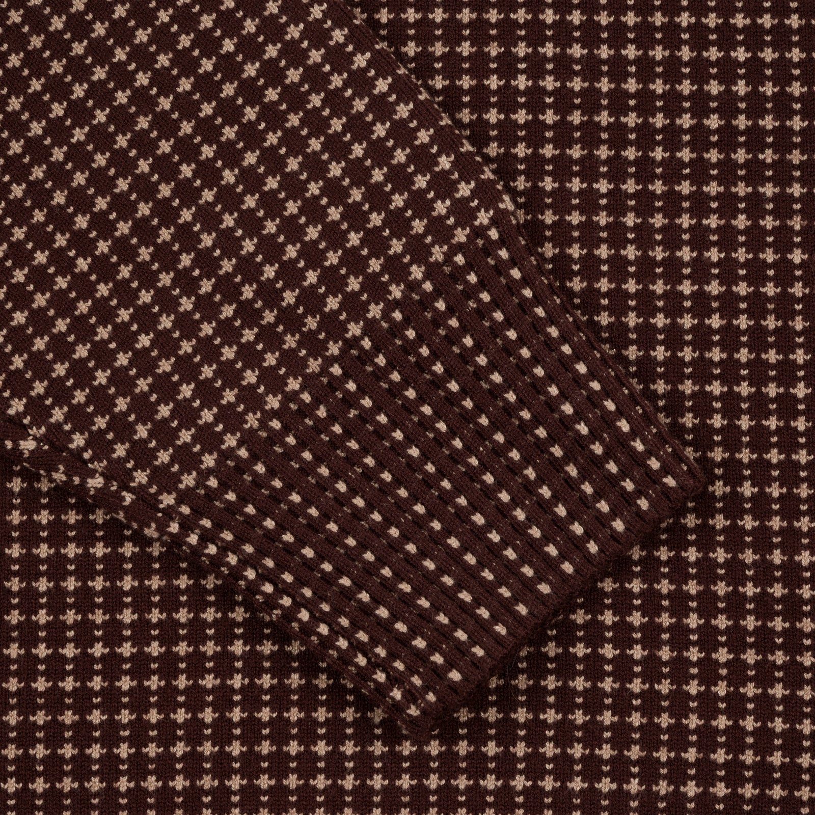 Close-up of Souvenir Jacquard Knit Sweater in chocolate color, showing detailed woven pattern on the sleeve.