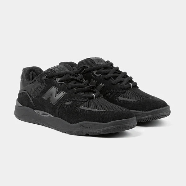 Black New Balance Numeric Tiago 1010 skate shoes with sleek design and durable sole, shown in a close-up side view.