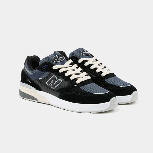 New Balance Numeric 933 Andrew Reynolds skate shoes in black and navy with white accents, featuring a durable design and padded collar.