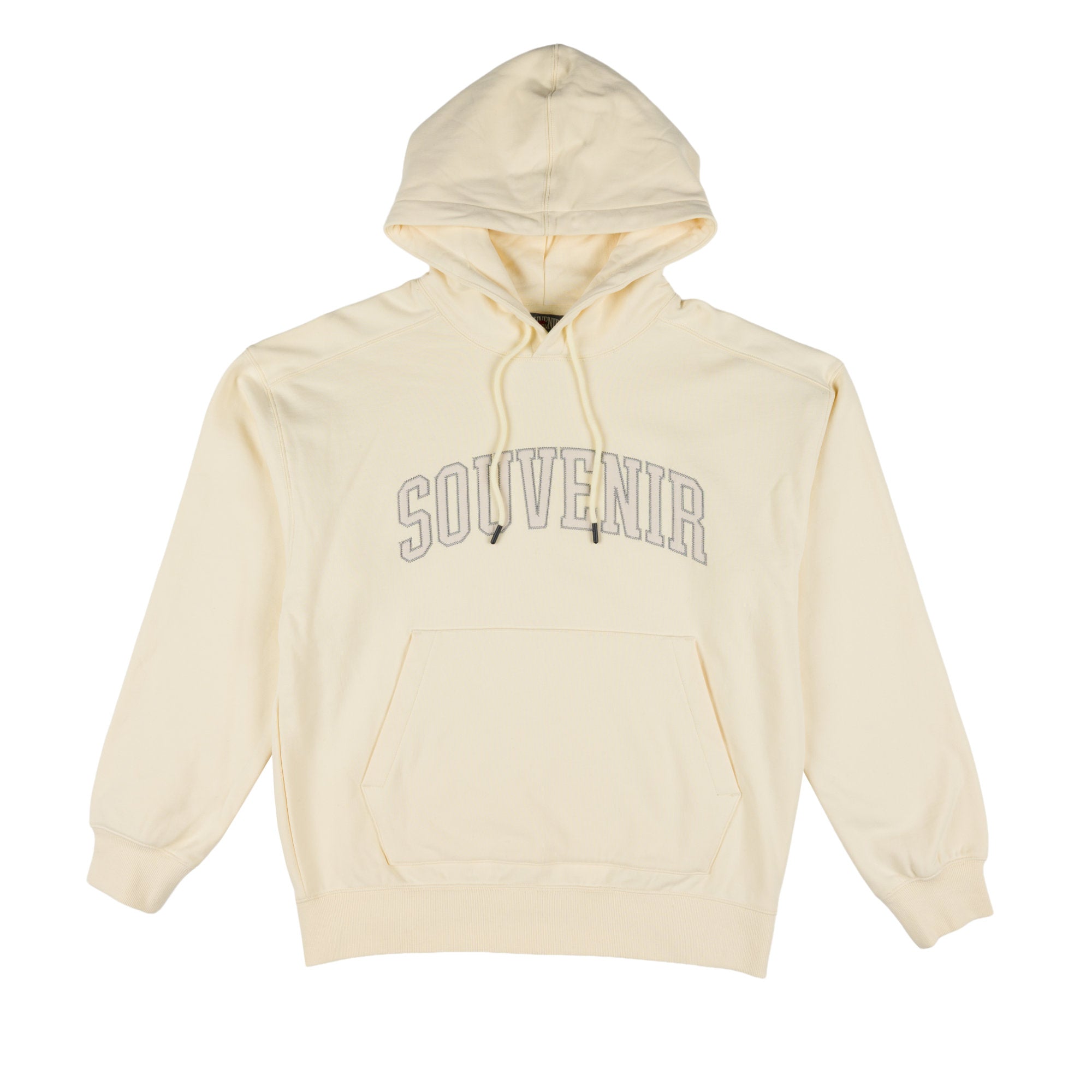 A cream-colored pullover hoodie with 'SOUVENIR' printed in gray outline block letters across the chest, displayed on a solid white background.