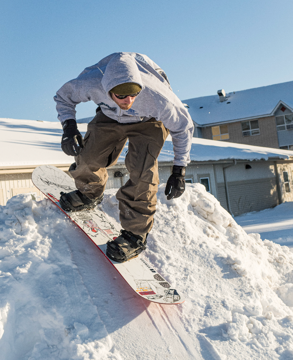 Armada snowboarder Danimals dropping into a powder street snowboarding spot on a Armada Beatnik Directional Twin Snowboard.