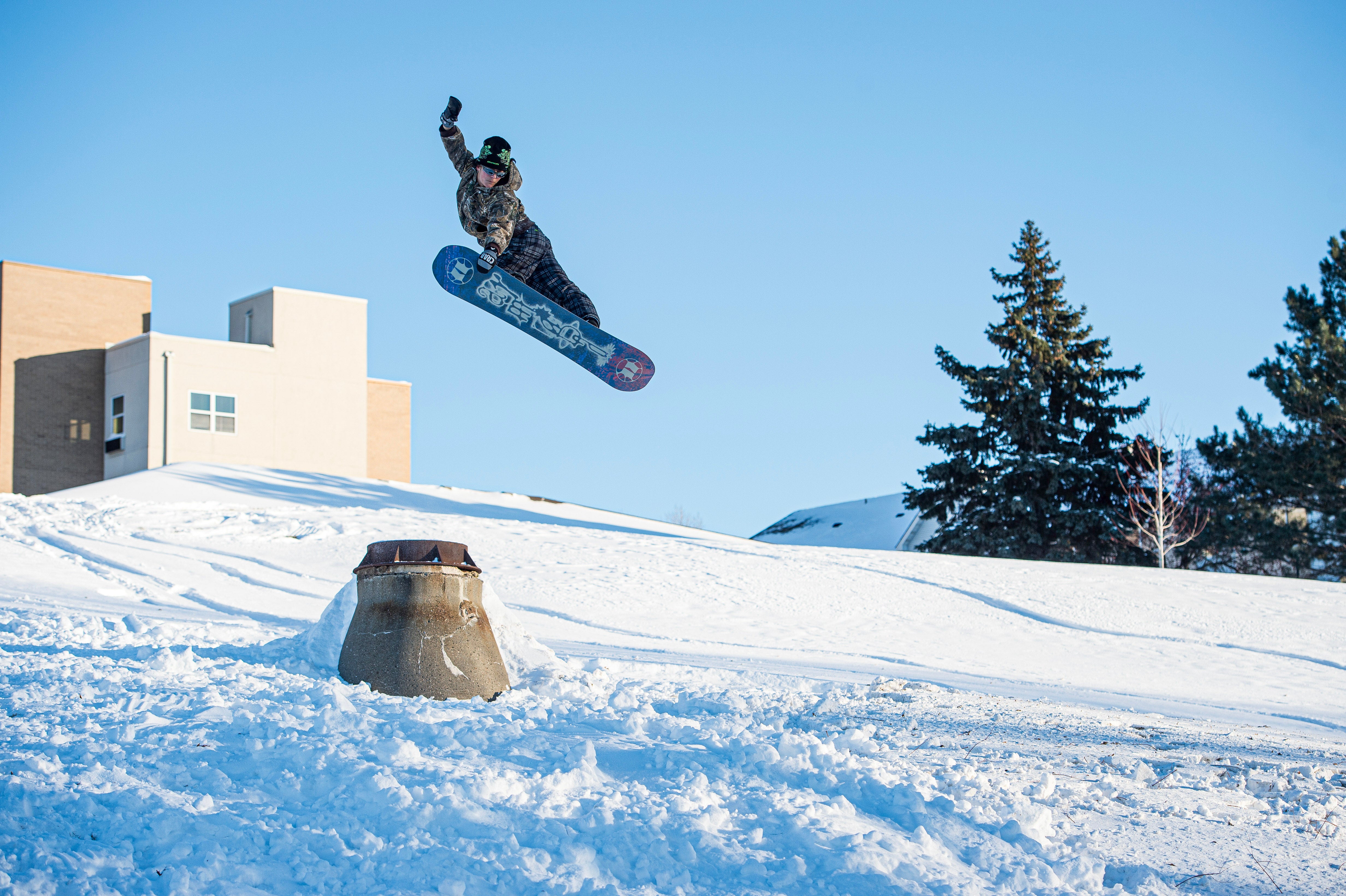 Armada Cold Press women's snowboard in winter scene, showcasing the snowboard with mountain background and snowy terrain.
