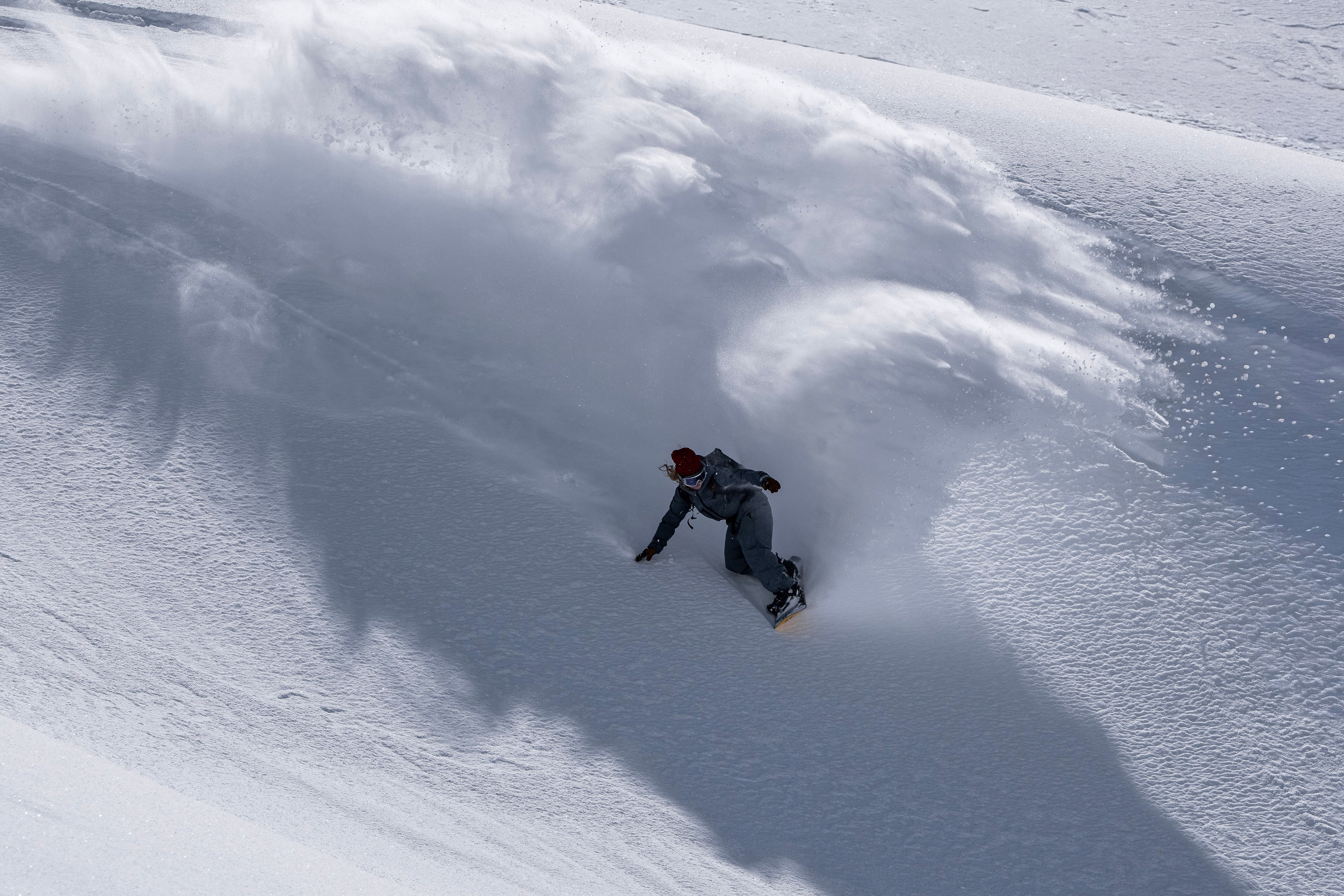Armada Kure women's snowboarding snowboard with colorful graphics, designed for all-mountain use in winter conditions.
