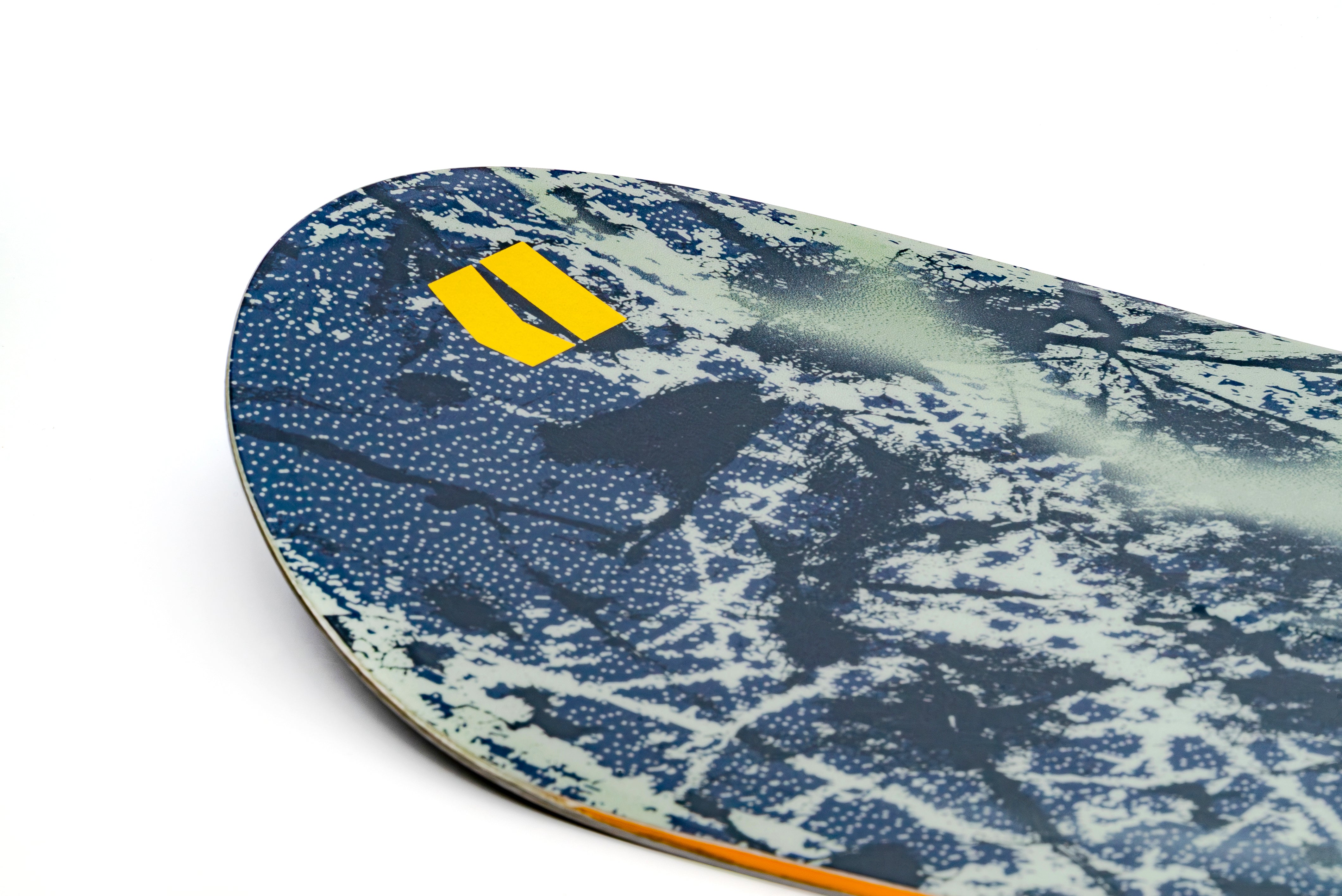 Armada Kure women's snowboard showing the nose design and graphics on a snowy surface for winter snowboarding.