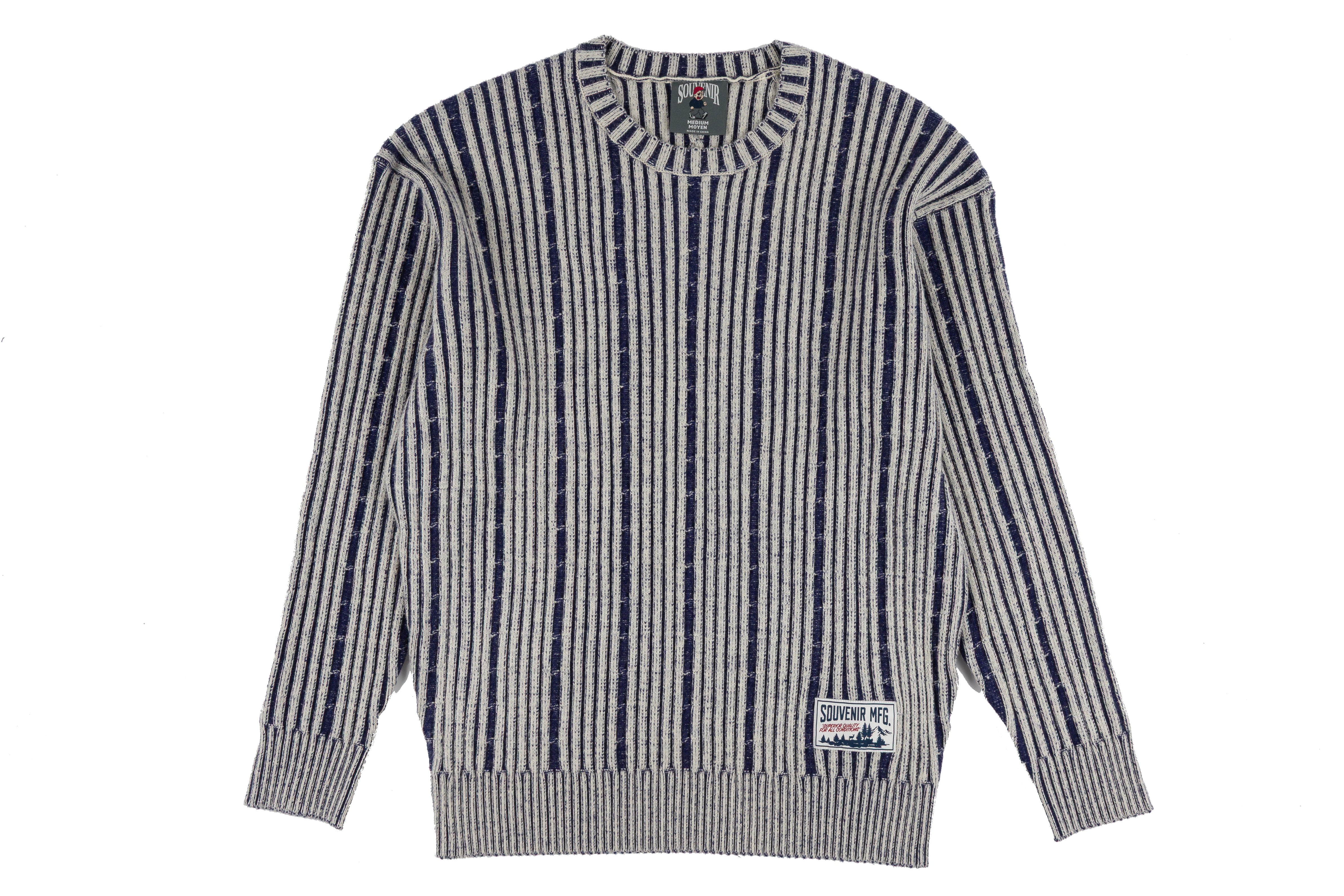 Souvenir chunky knit sweater for men and women, cozy and stylish in a chunky knit design, shown in a natural fabric texture.