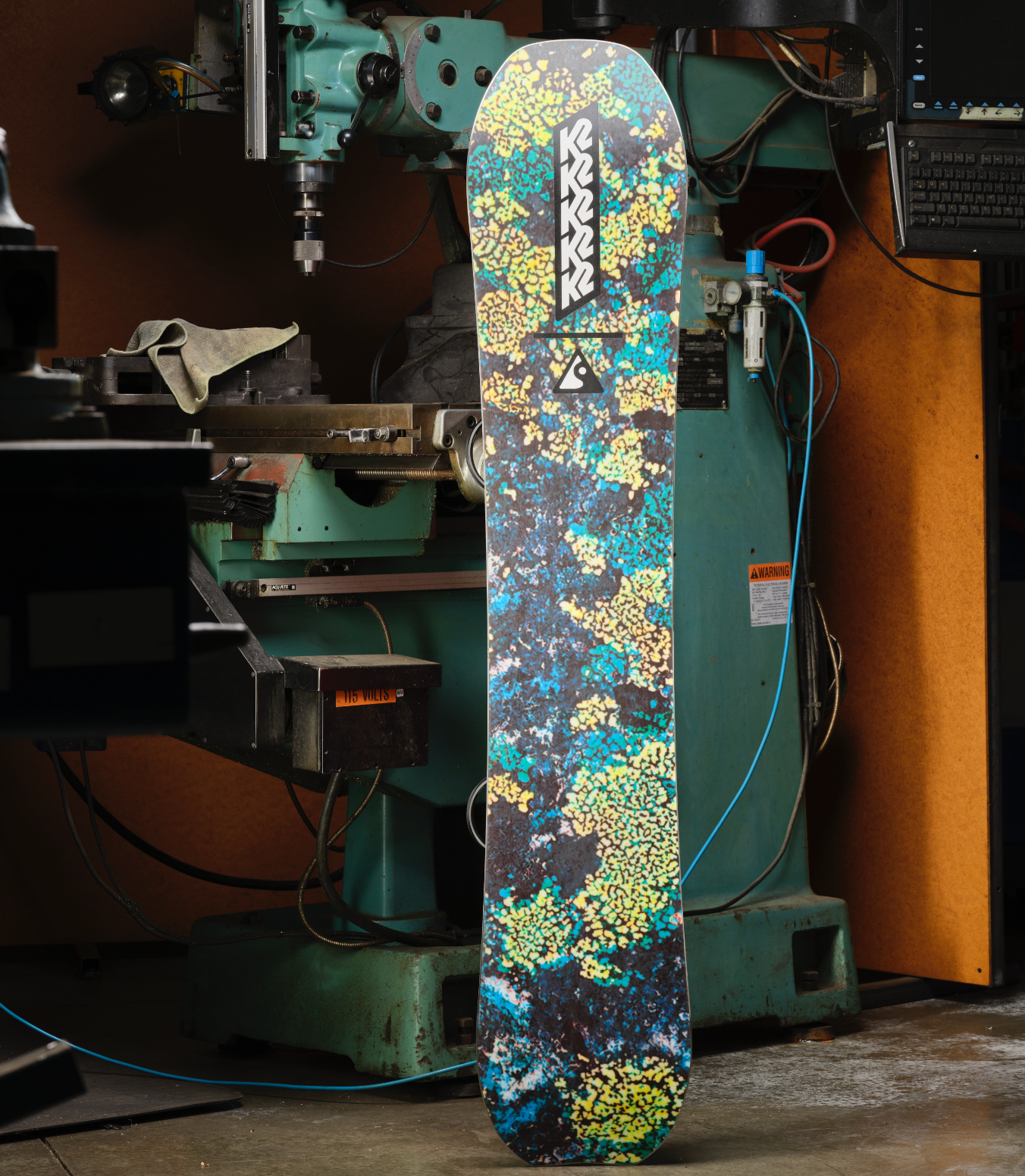 K2 Passport snowboard 2027 with factory base, showing the textured base surface and design details on the snowboarding equipment.