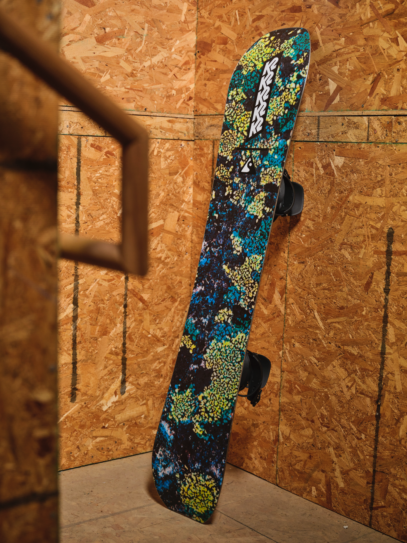 K2 Passport Snowboard base with milosport graphics, showing the snowboard's underside and textured surface for snowboarding.