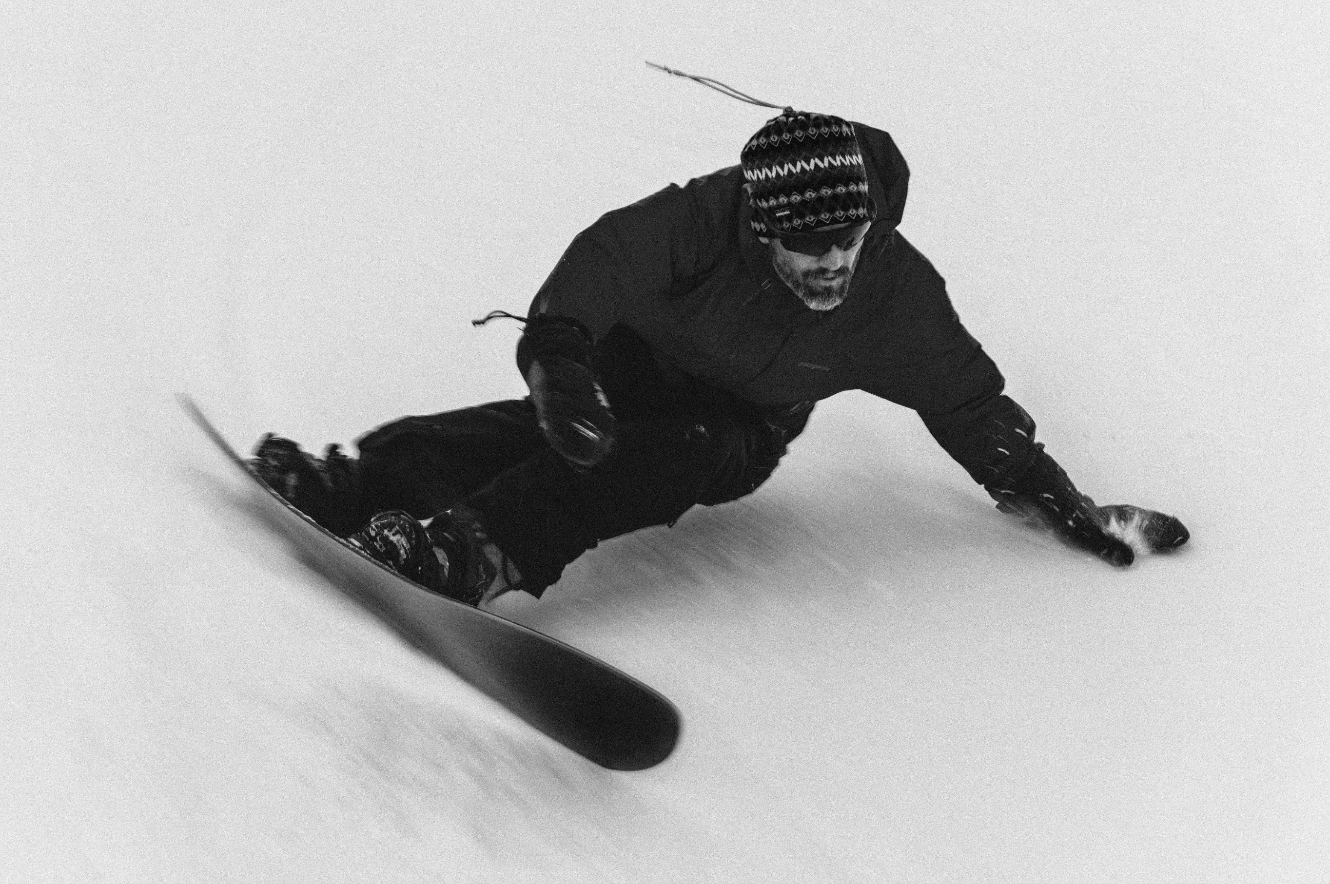 Korua Dart snowboard with Nicholas Turn riding in snow, showcasing its sleek design and performance in winter conditions.