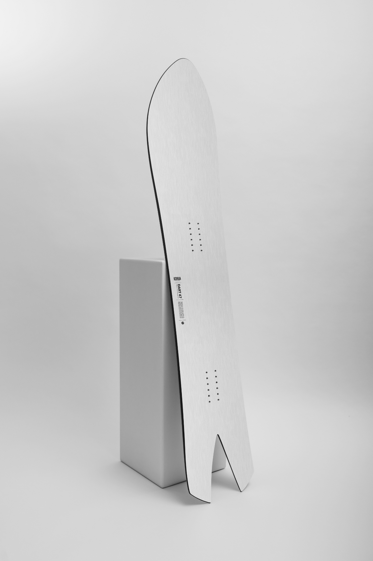 Korua Dart Snowboard in a studio setting, showcasing the snowboard's design and shape for winter snowboarding.