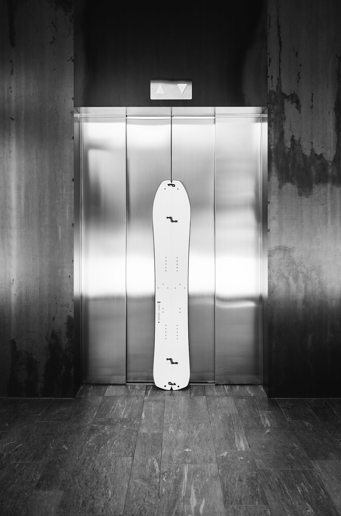 Korua Elevator Split Plus snowboard with a sleek design, suitable for snowboarding in winter conditions.