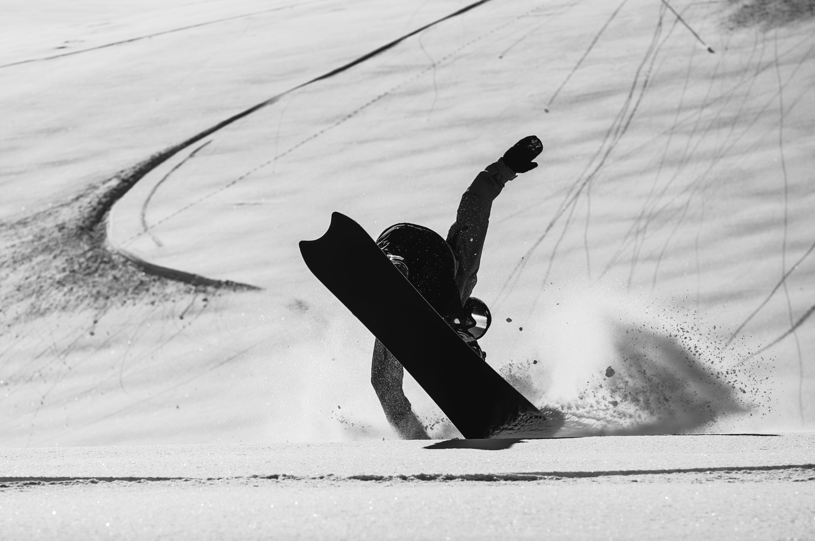Korua Pencil Plus snowboard in snow color, showing a playful butter slide with a sleek design and brand logo on the base.
