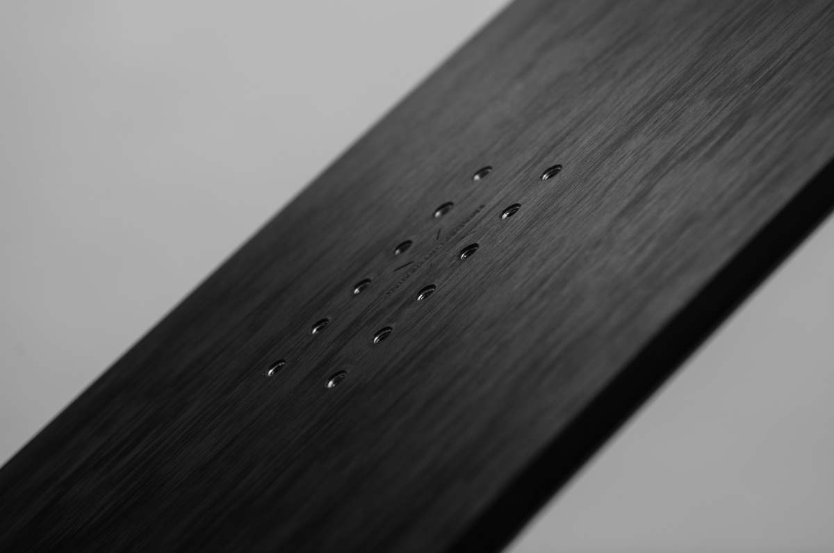 Close-up of Korua Bullet Train Plus snowboard showing its shape and design details on snow.