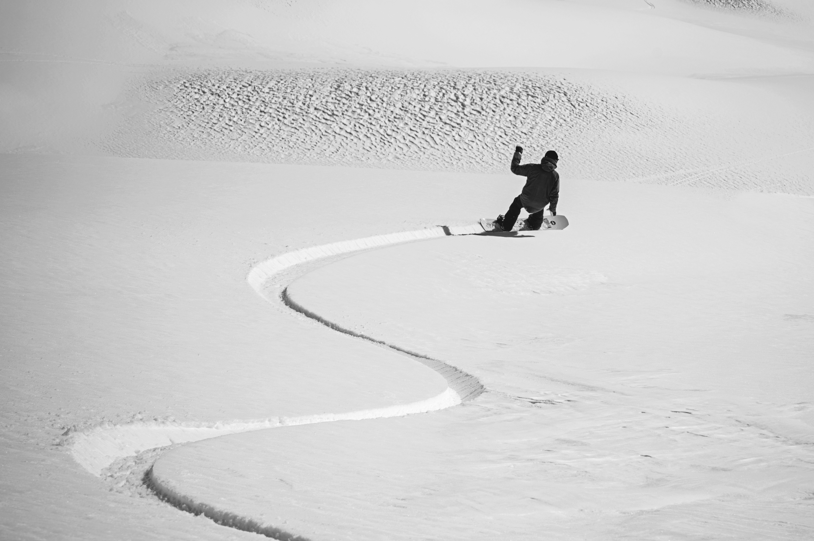 Korua Transition Finder snowboard on snow showing rider making turns