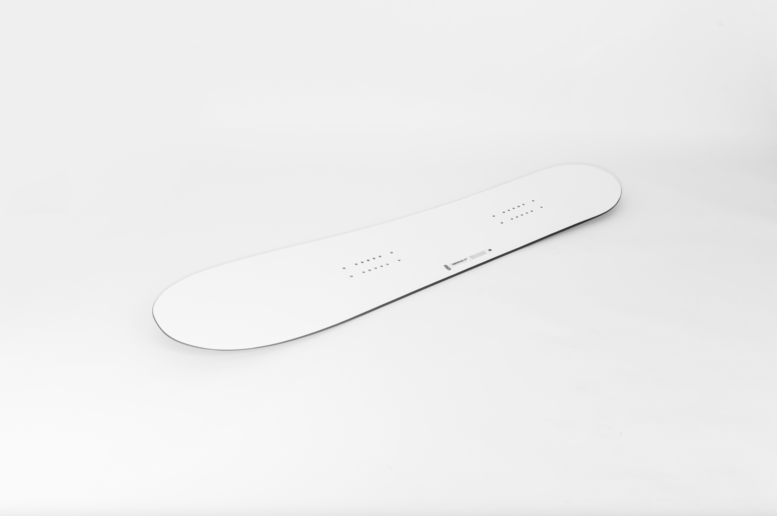 Korua Uberegg snowboard on snow, showing its unique shape and design, ready for winter riding and snowboarding adventures.