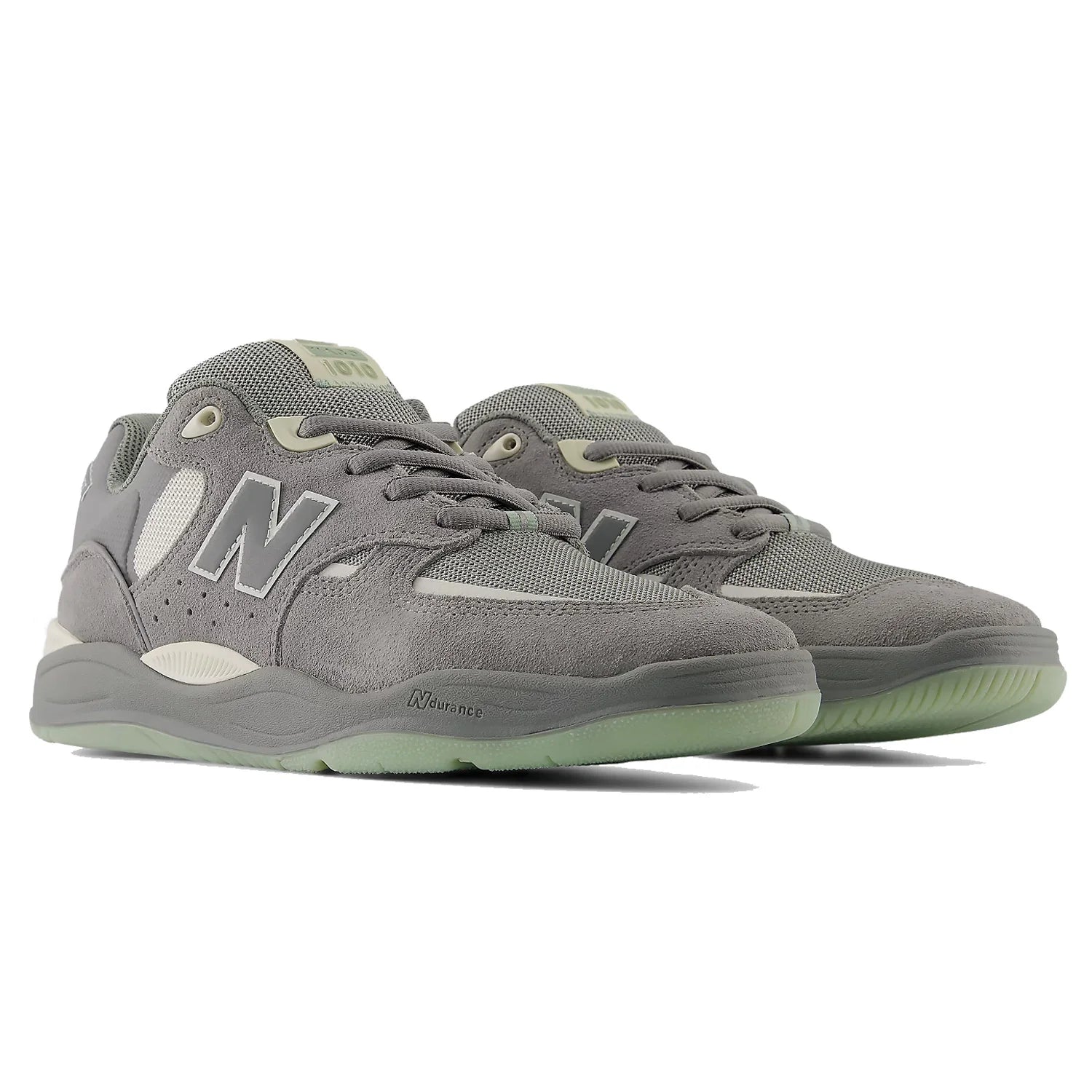 Pair of New Balance Numeric Tiago 1010 skate shoes in Slate Grey and Sea Salt shown from a front three-quarter angle.