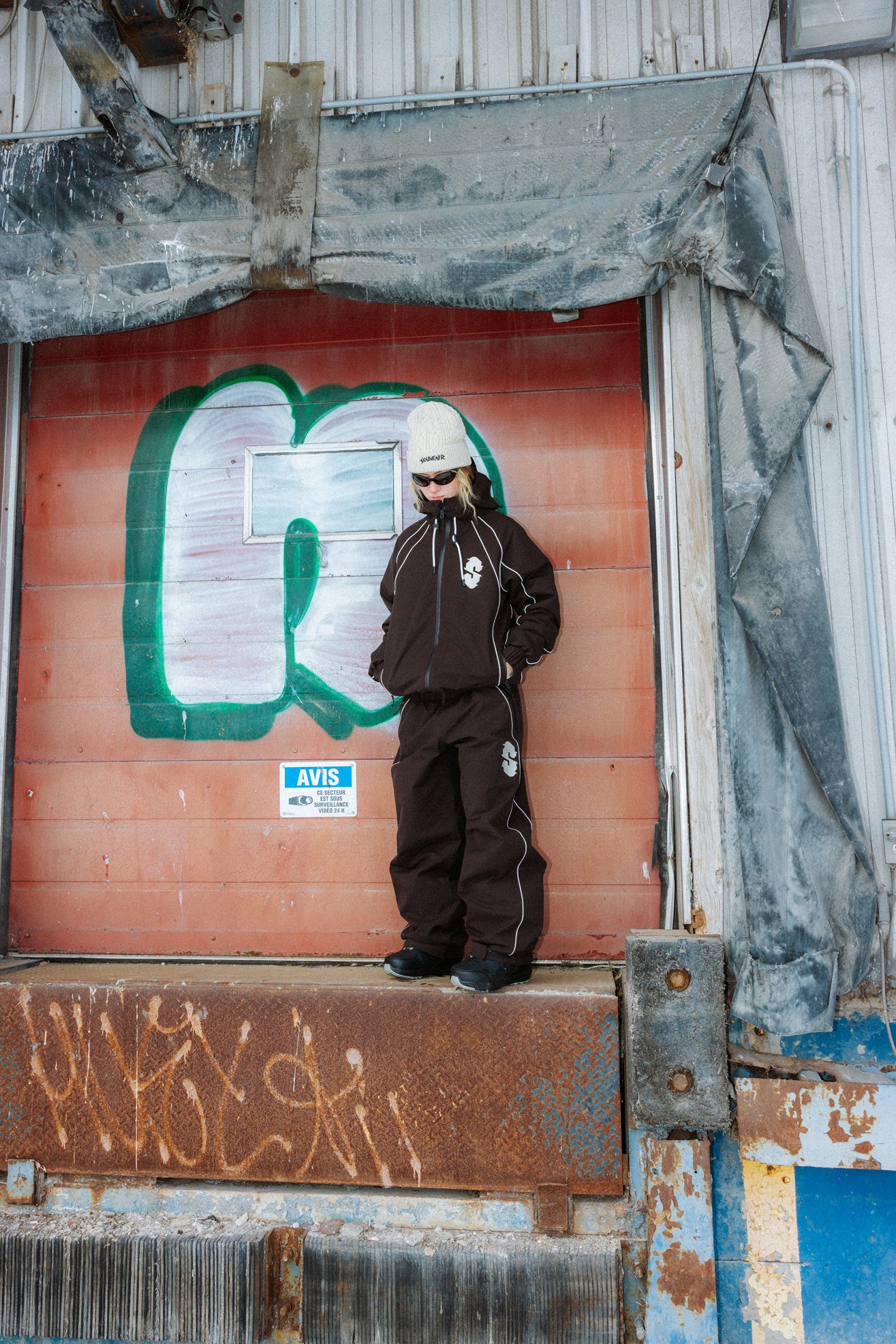 Full-length lifestyle view of the Souvenir Insulated Track Pant and Jacket 2027 in Cocoa.