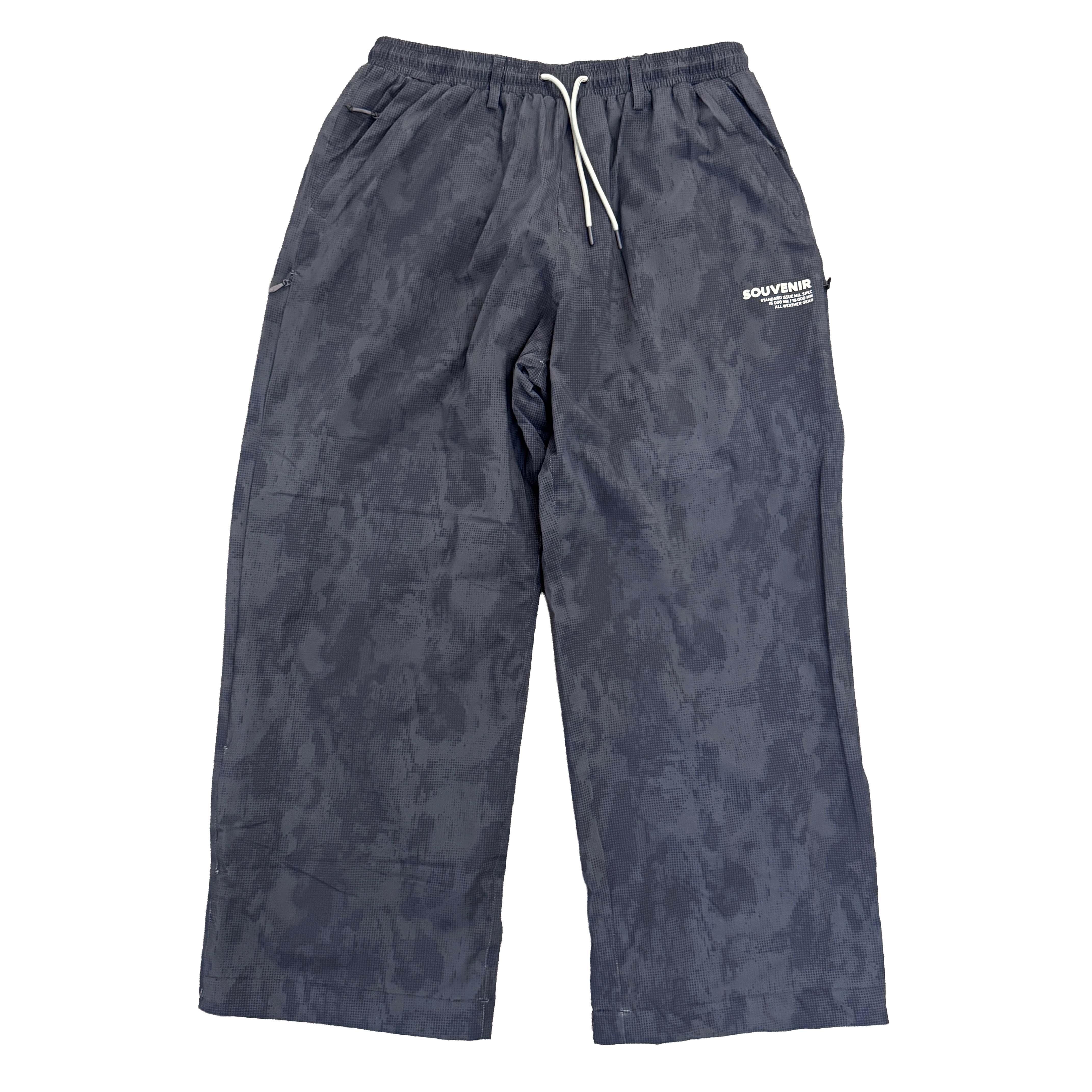 Souvenir Parachute Pant 2027 in Black Blotch Print shown from the front with extra-baggy fit, elastic drawstring waist and Souvenir thigh branding.