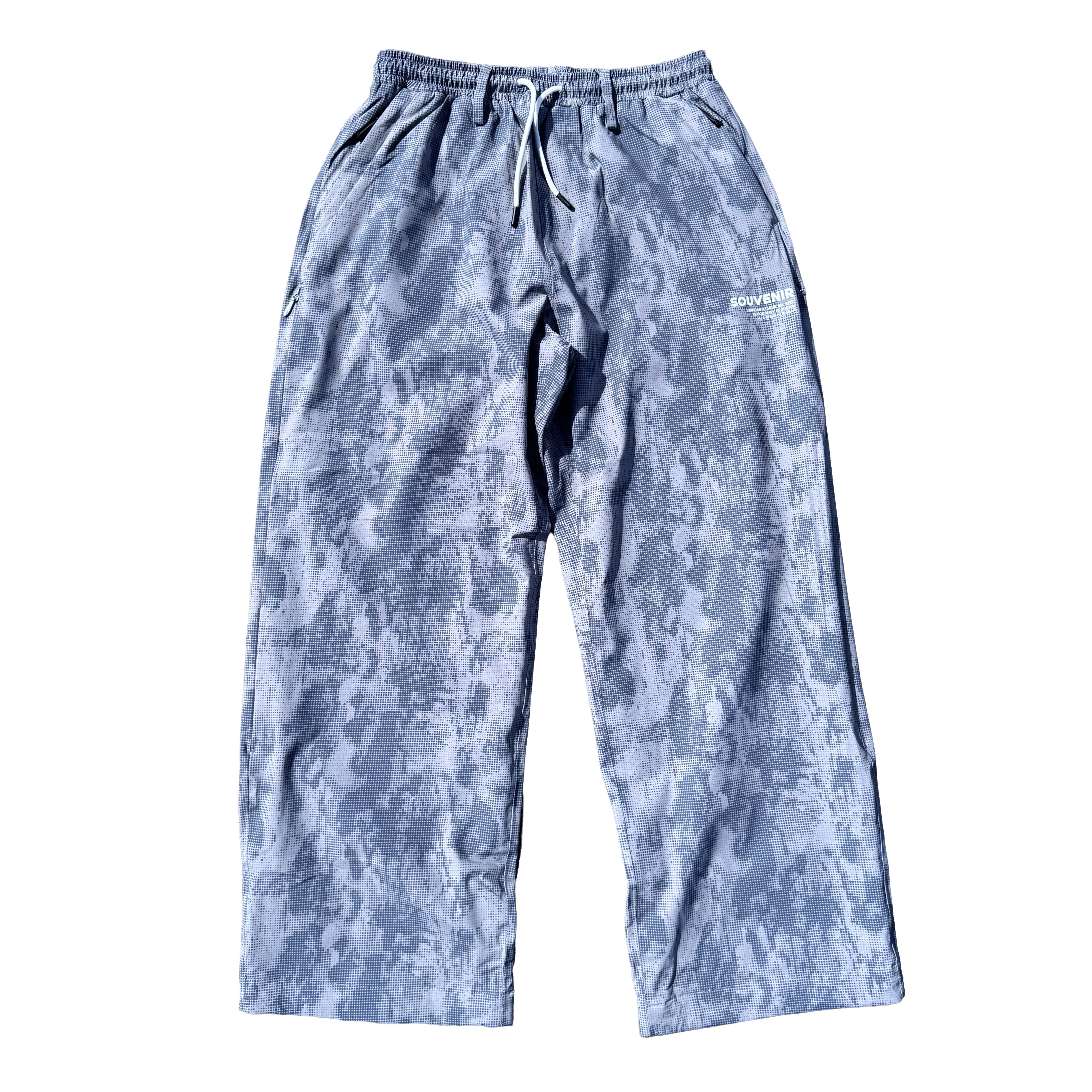Souvenir Parachute Pant 2027 in Cool Grey Blotch Print shown from the front with oversized parachute fit, elastic drawstring waist and zippered hand pockets.