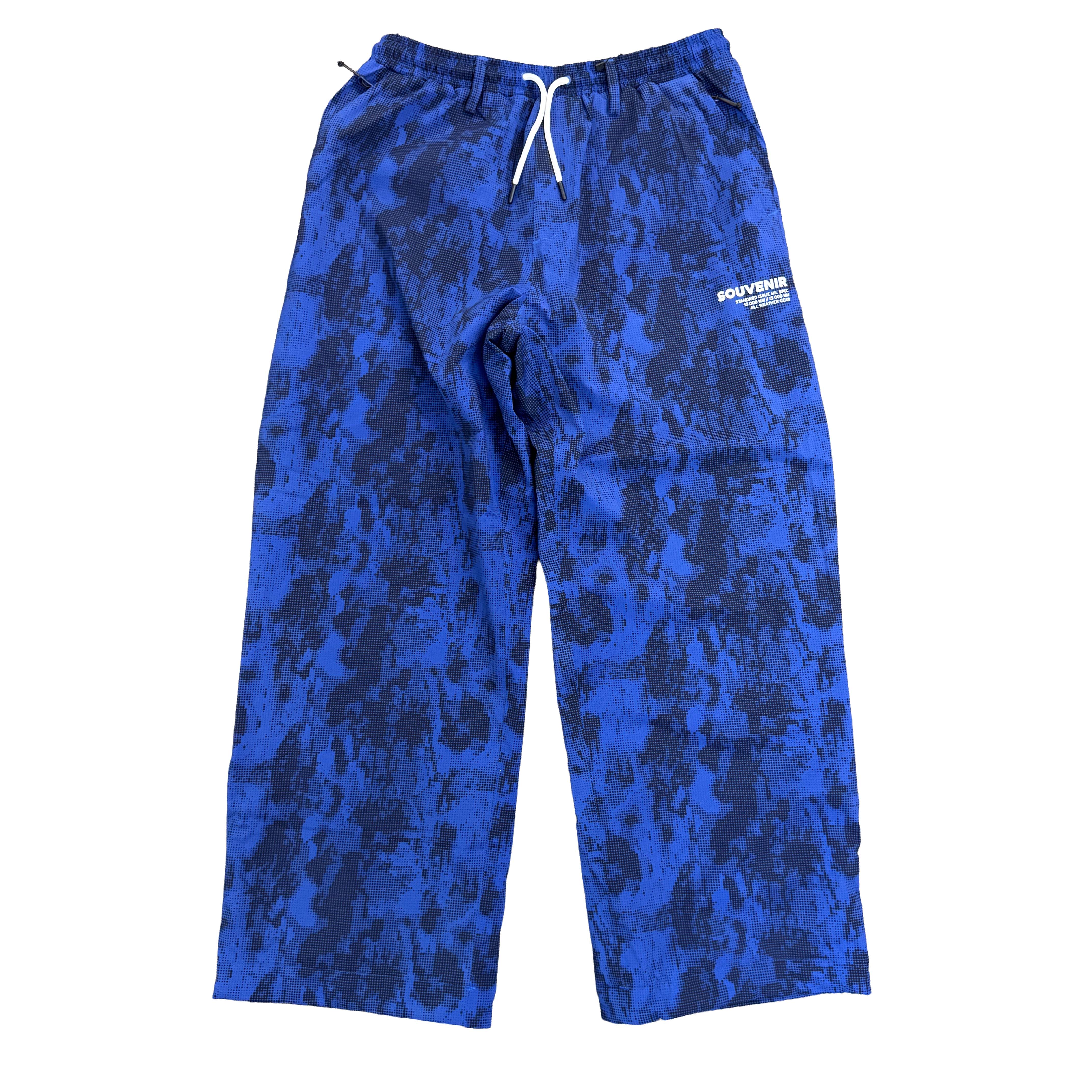 Souvenir Parachute Pant 2027 in Petrol Blue Blotch Print shown from the front with oversized baggy fit, elastic drawstring waist and Souvenir thigh logo.