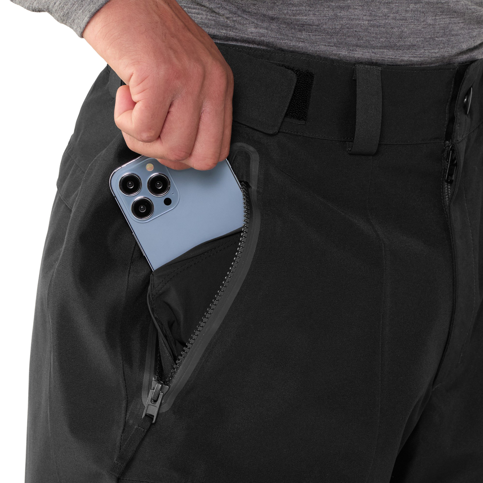 Close-up of the zippered hand pocket on The North Face Men’s GORE-TEX Hex Pants in TNF Black with a phone being placed inside.