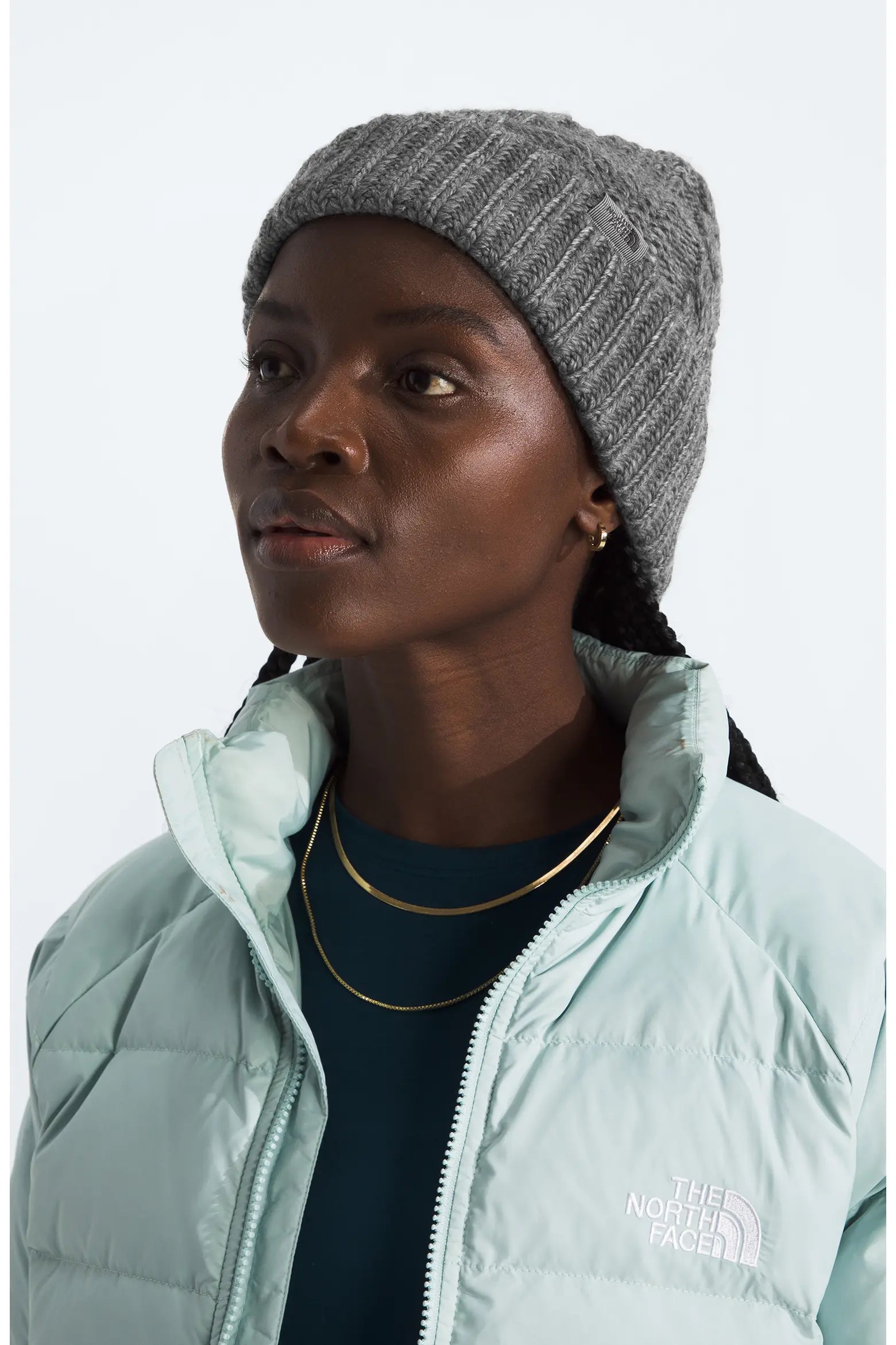 Lifestyle view of The North Face Women’s Oh Mega Beanie in Heather Gray with ribbed knit construction