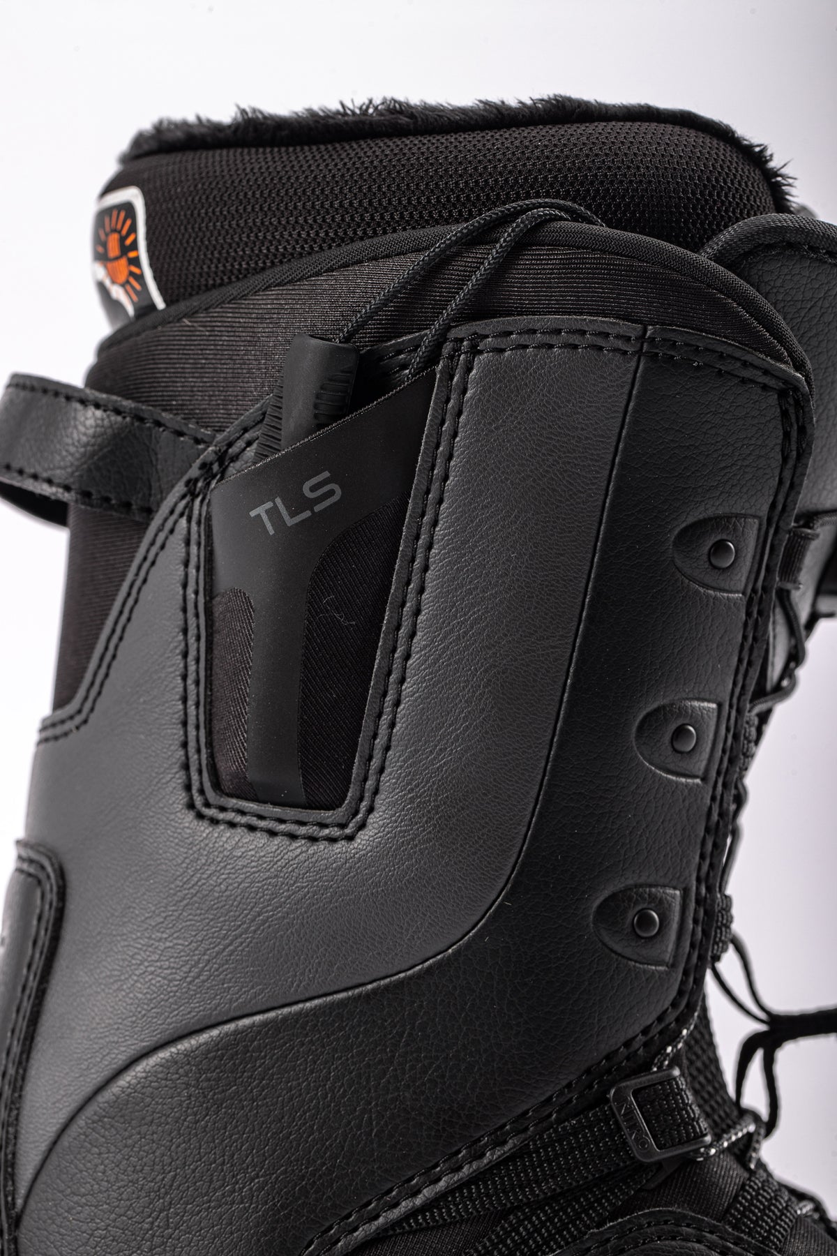 Side view of Nitro Crown TLS Women's Snowboard Boots 2027, featuring black design and side pocket detail.