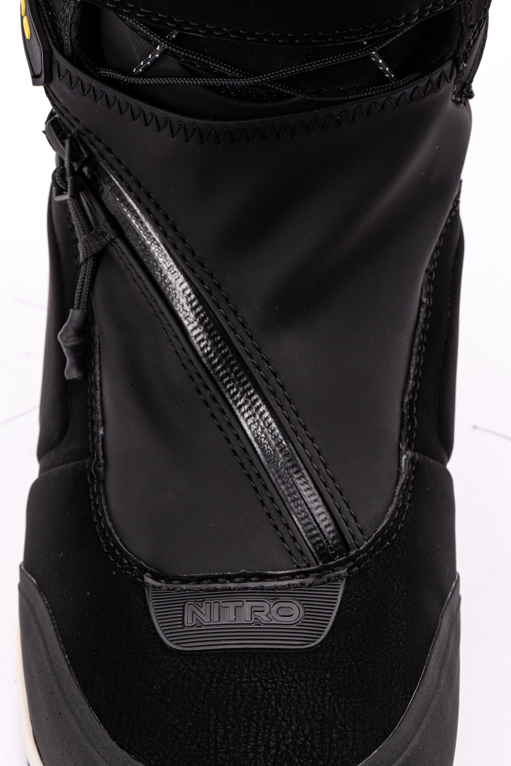 Nitro Team Pro Kleveland TLS Snowboard Boots 2027 with gaiter, black and white design, showing the boots on snow for winter snowboarding.