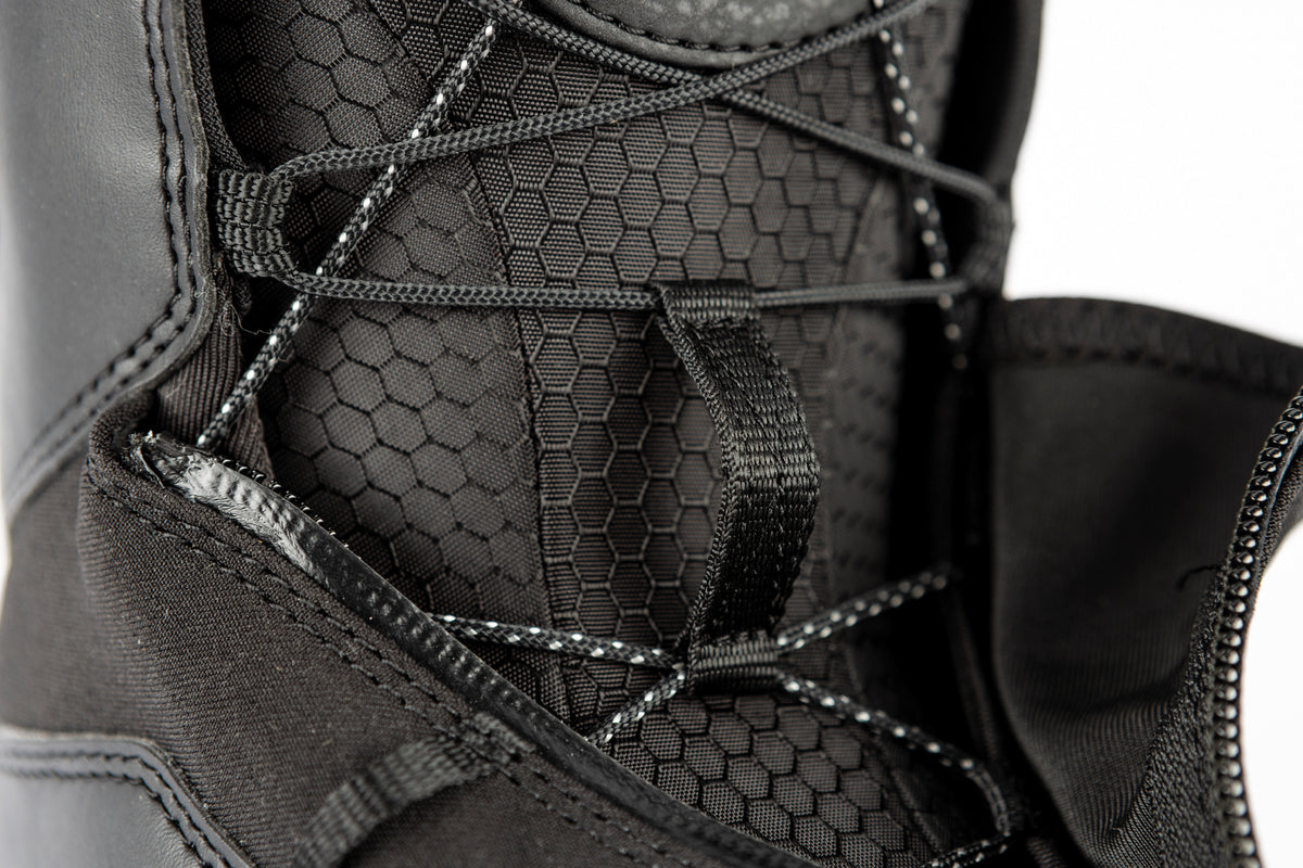 Black Nitro Venture Pro TLS snowboard boots with laces, designed for winter snowboarding, featuring a sturdy, supportive fit.