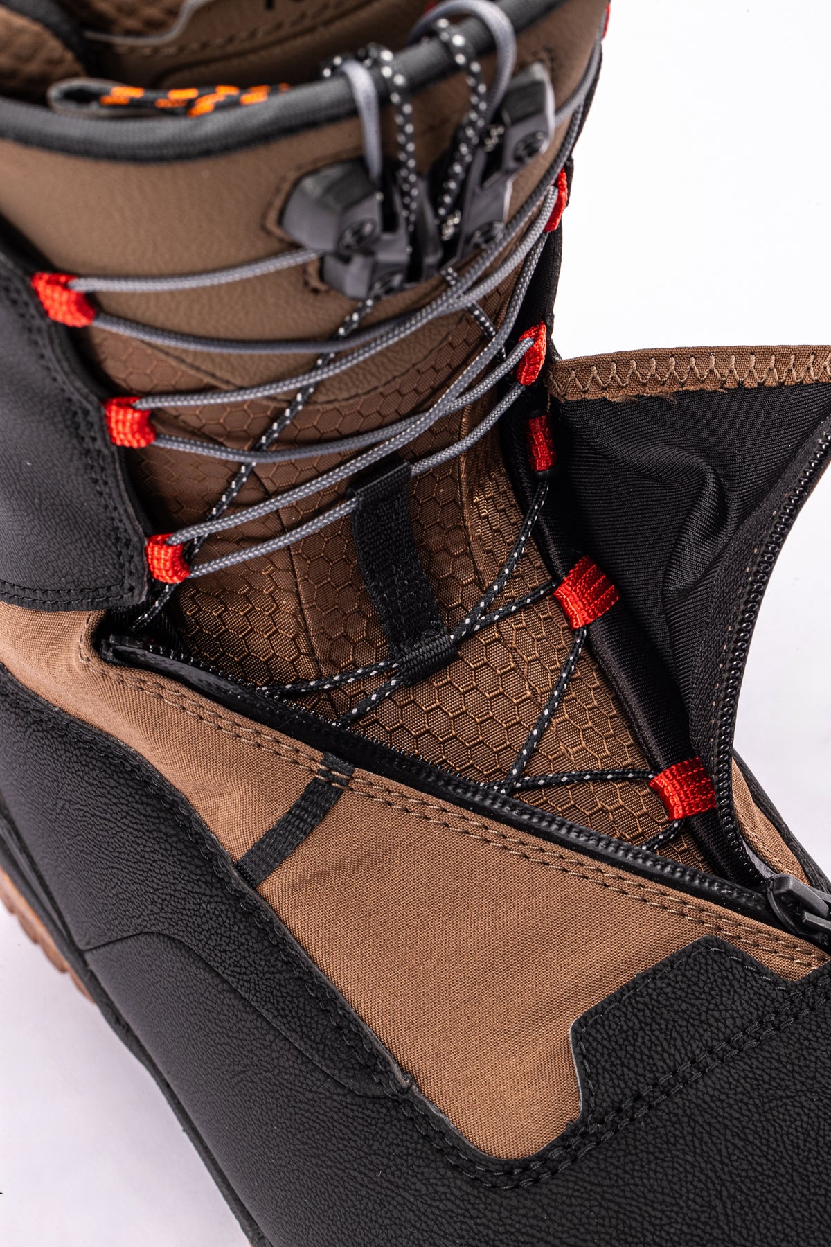 Brown and black Nitro Venture Pro TLS snowboard boots unzipped, showcasing the comfortable interior and sturdy design.