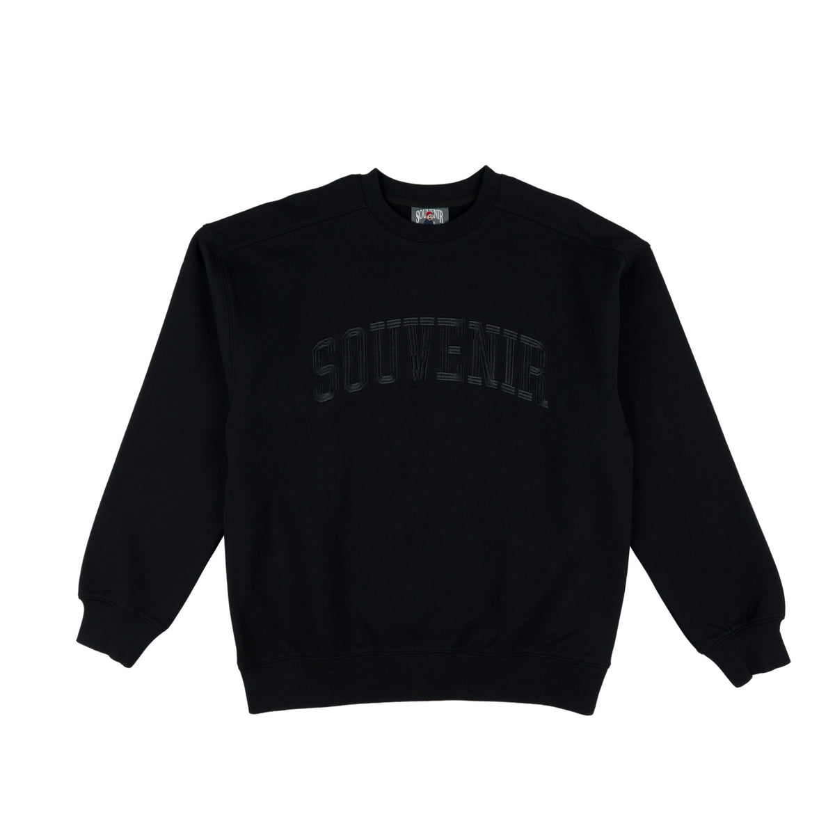A black crewneck sweatshirt with 'SOUVENir' printed in a tonal, dark gray/black arched font across the chest, displayed flat against a solid white background.