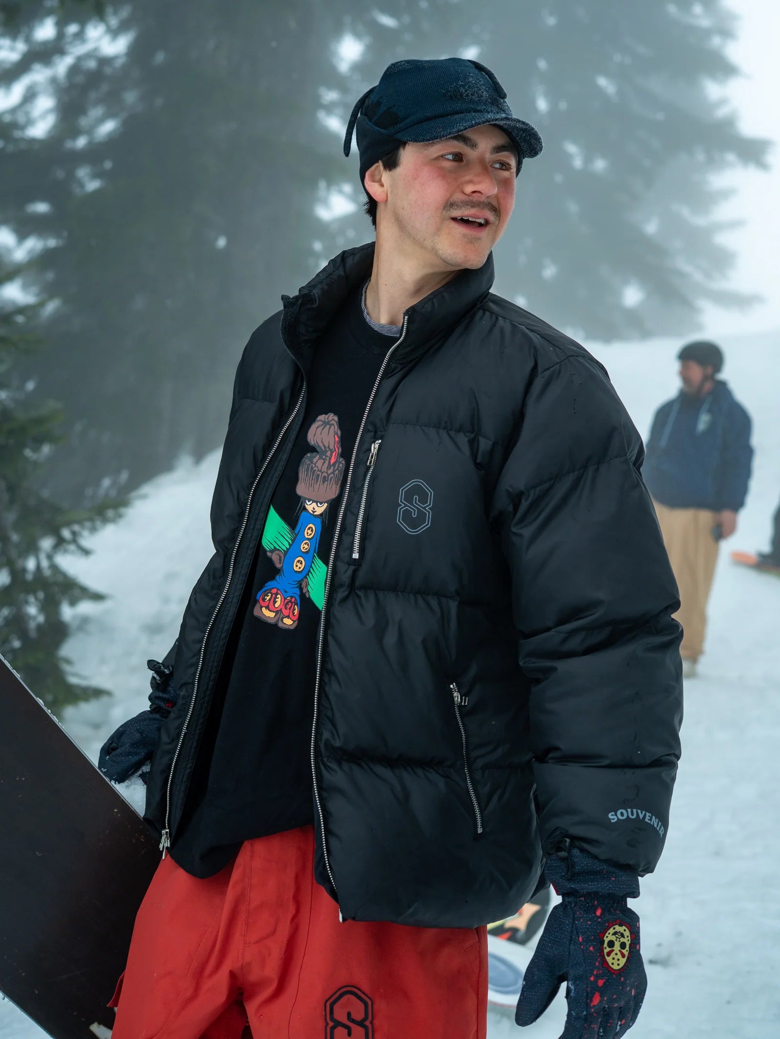 Black Souvenir Everyday Puffer 2026 jacket displayed on a model, showcasing its puffy design and stylish fit.