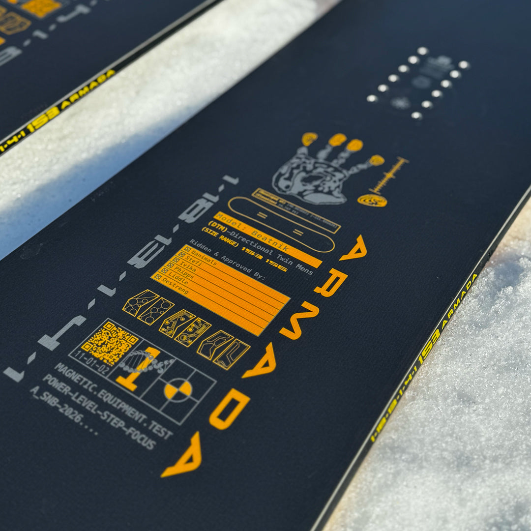 Armada Beatnik LTD snowboard in snow, showcasing the sleek design and graphics of this high-performance winter sport equipment.
