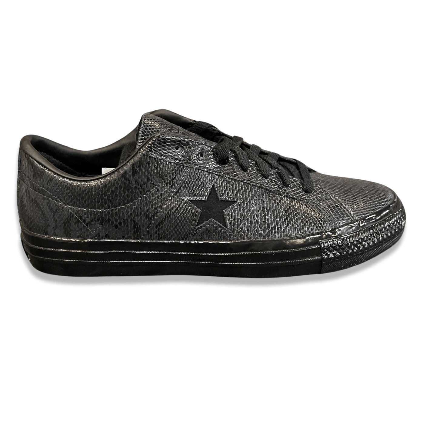 Converse One Star Pro Ox black and white shoes, casual sneakers with leather upper and rubber sole, on a plain background.