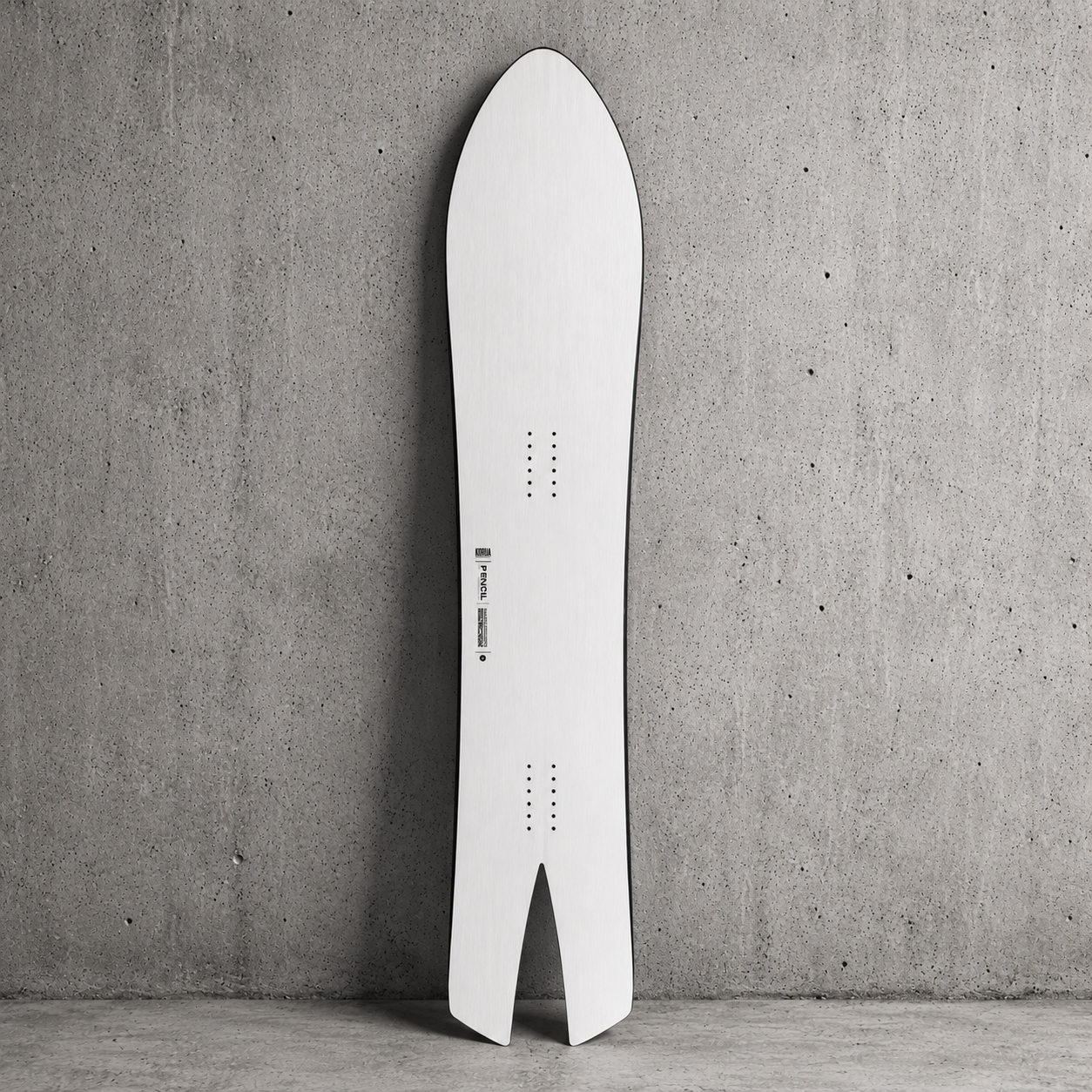 the korua stork snowboard shown on a cement background, with the korua logo on the topsheet and the 4x2 insert pattern for milosport
