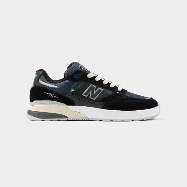 New Balance Numeric 933 Andrew Reynolds skate shoes in black and navy with white accents, showcasing the side view and design details.