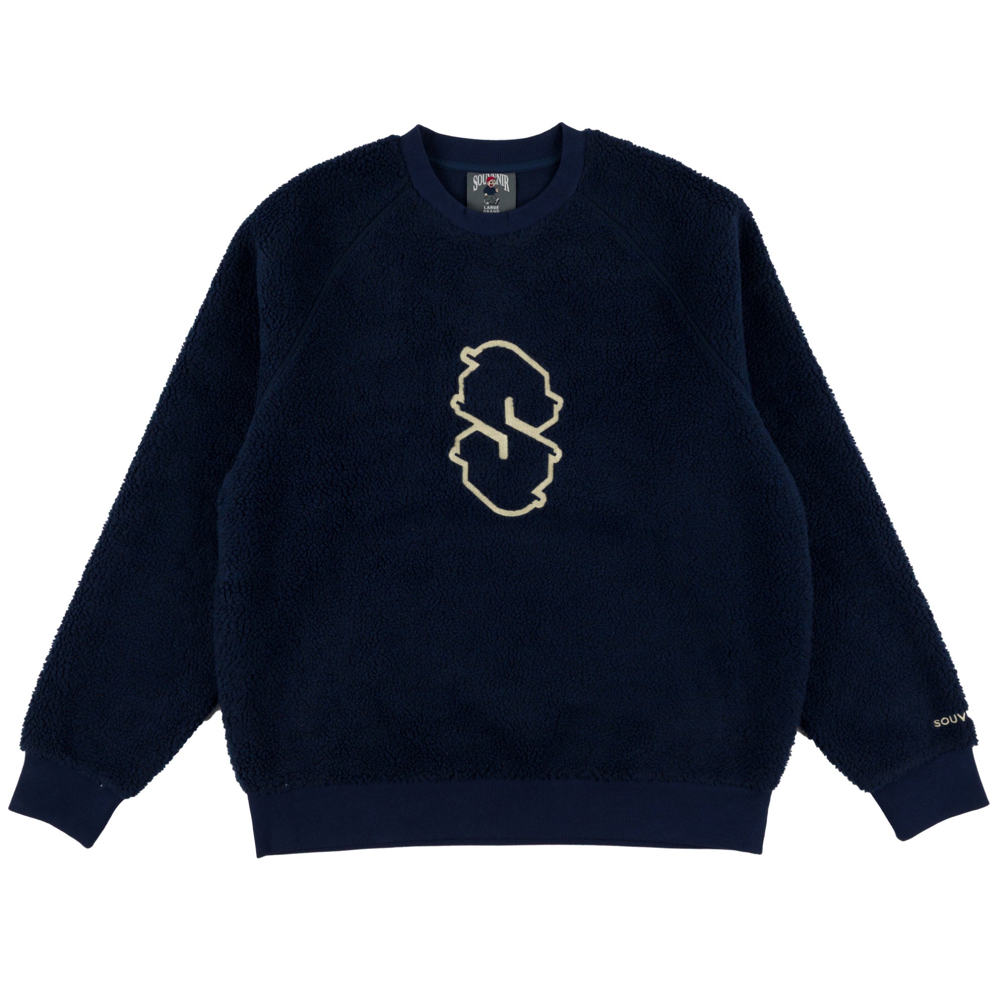 A navy blue Souvenir sherpa fleece crewneck sweatshirt with a gold embroidered 'S' logo on the chest, displayed flat against a white background.