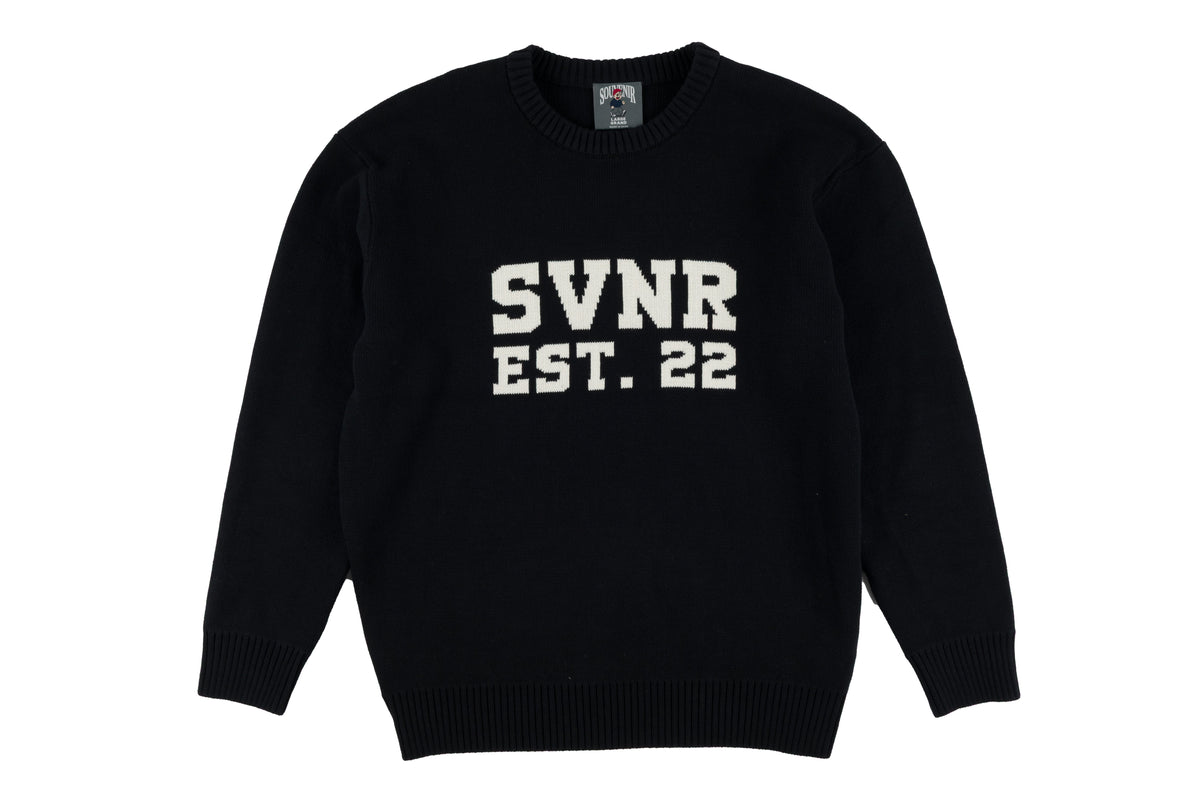 Souvenir collegiate jacquard knit sweater for men and women featuring school emblem and detailed knit pattern.