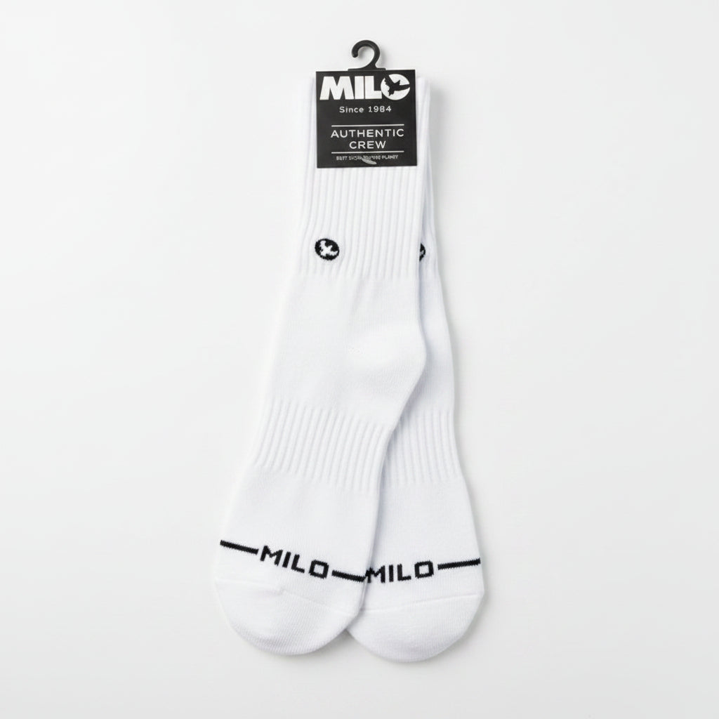 White socks with black branding on a concrete surface