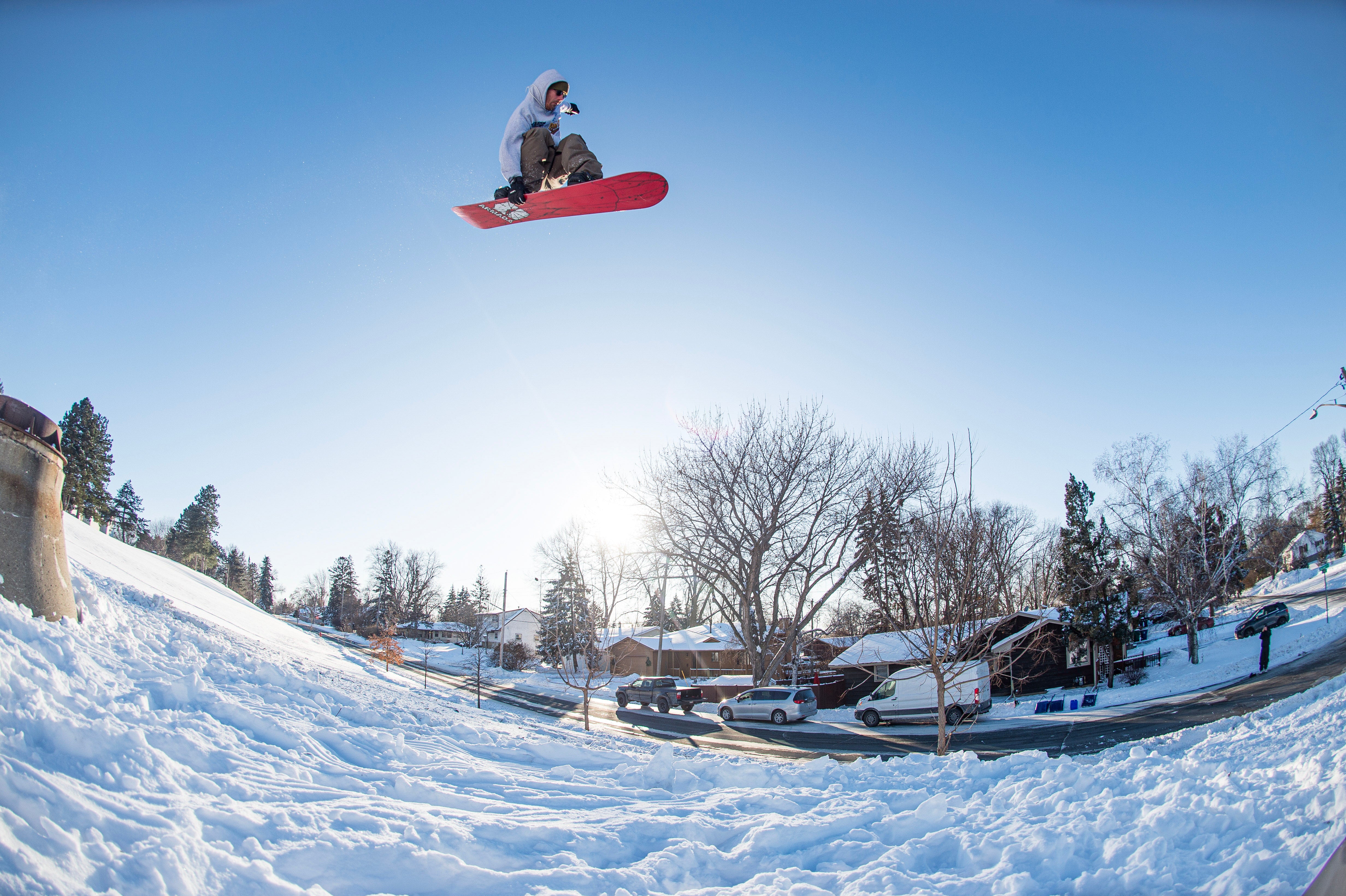Armada Beatnik Snowboard 2027 with Danimals doing an Indy Grab in at a Street Spot with the Red Base Showing