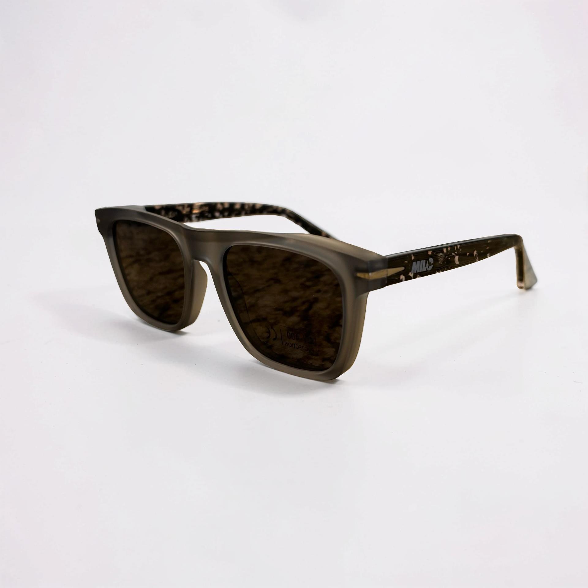 Sunglasses with grey lenses and grey tortoiseshell frame on a white background