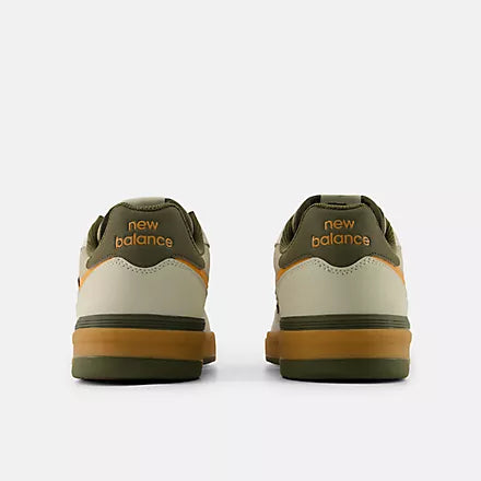 Rear view of a pair of New Balance Numeric 306 Cup Foy skate shoes showing olive heel panels, New Balance branding and gum midsoles.