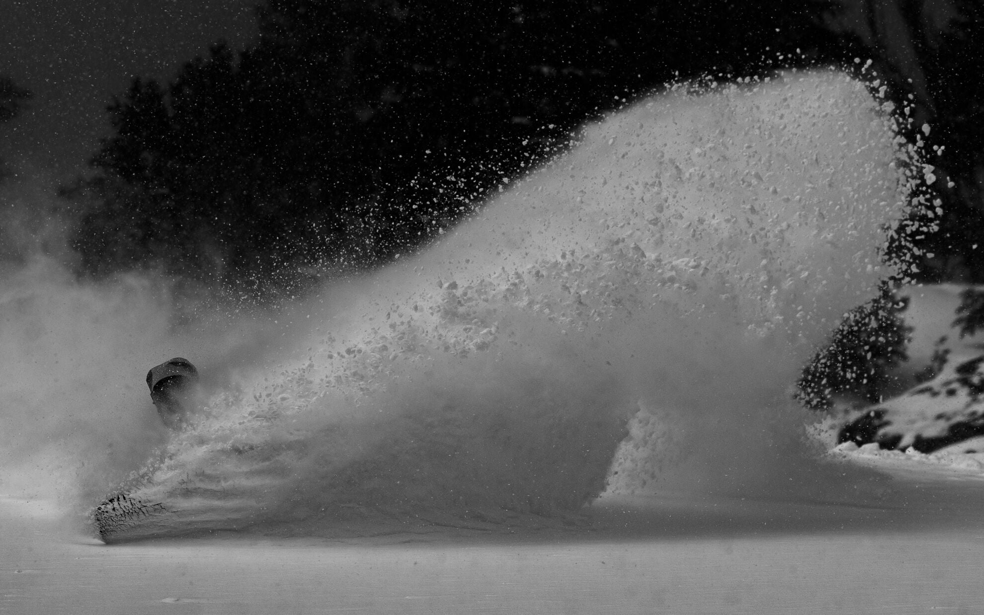 Jones Mountain Surfer Snowboard 2027 in action, showcasing its sleek design and versatile shape for mountain snowboarding.