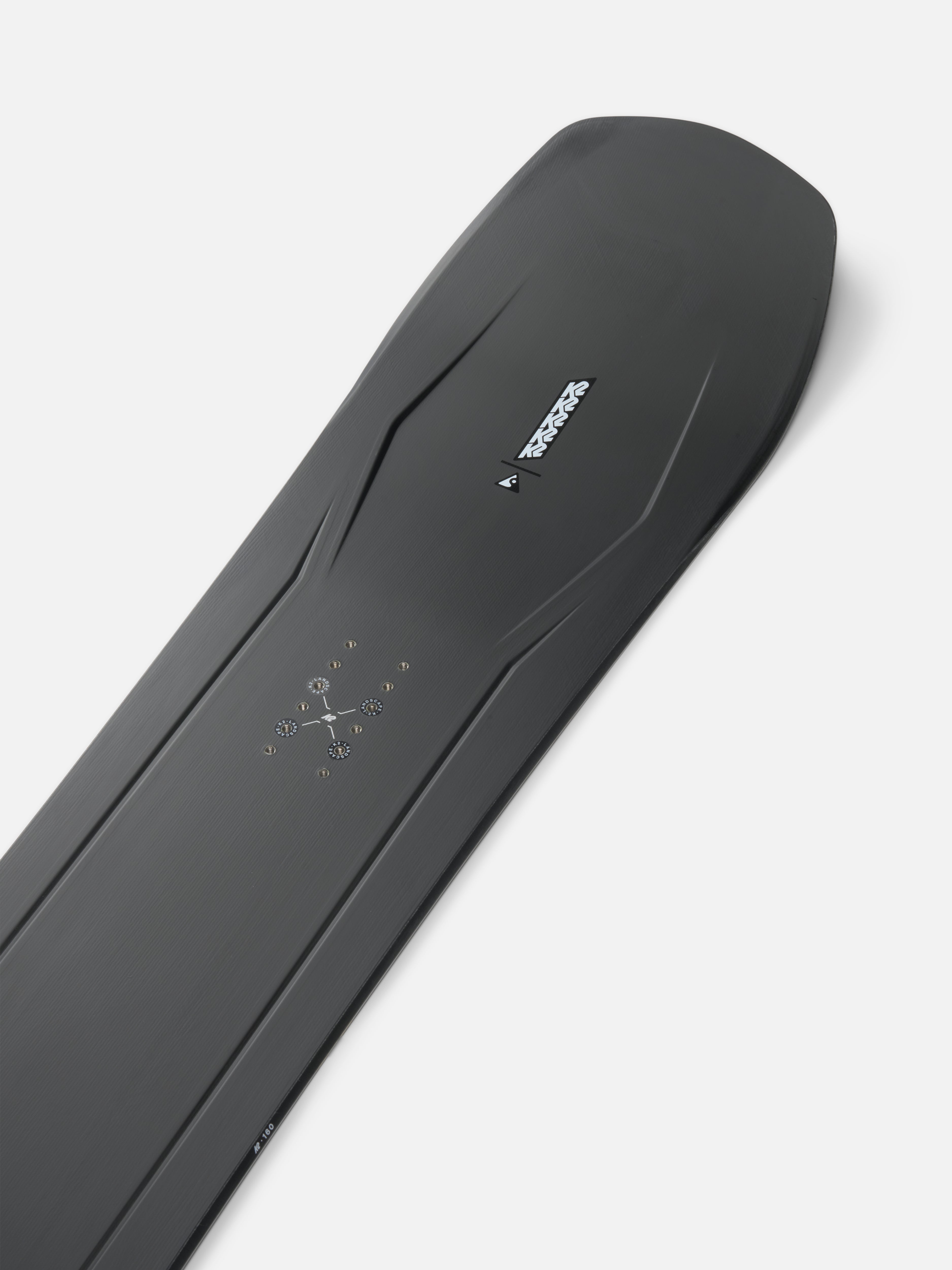 K2 Alchemist snowboard with clean nose design, showcasing the K2 brand logo and sleek winter snowboarding surface.