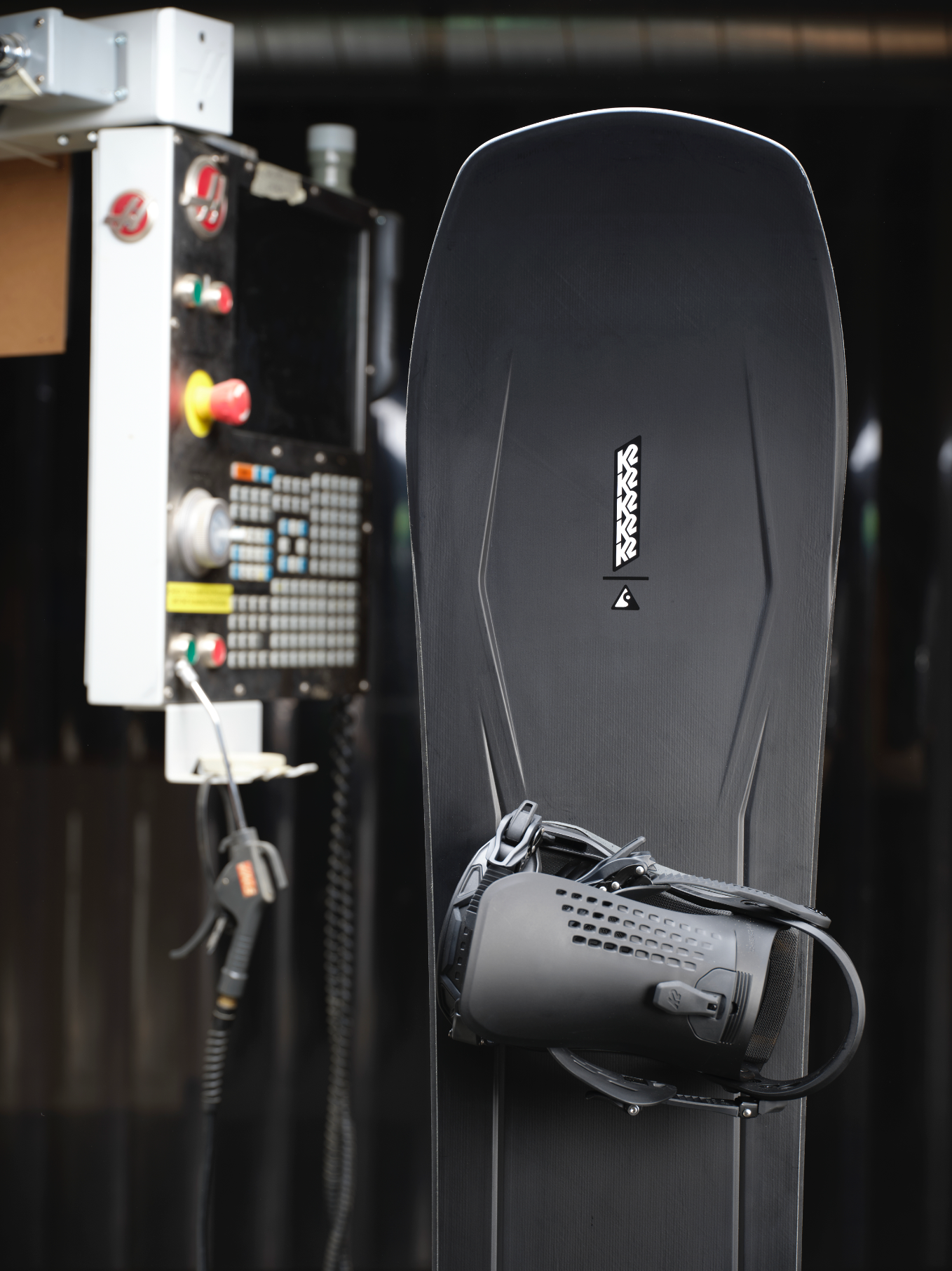 K2 Alchemist snowboard showing the nose with a sleek design and graphics, ideal for all-mountain snowboarding.