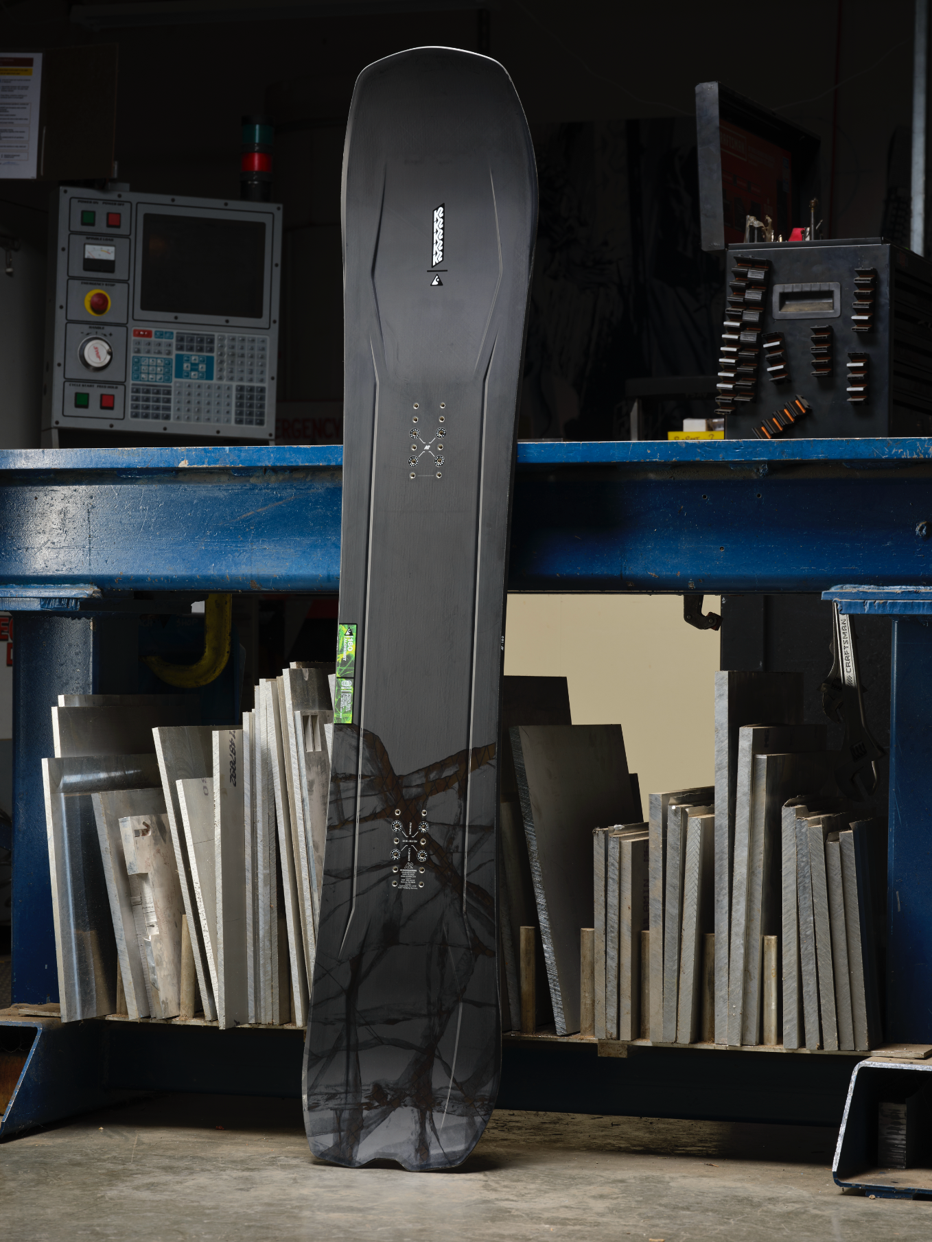 K2 Alchemist snowboard for 2027 with a sleek design, displayed on snow, featuring the K2 branding and a modern graphic.