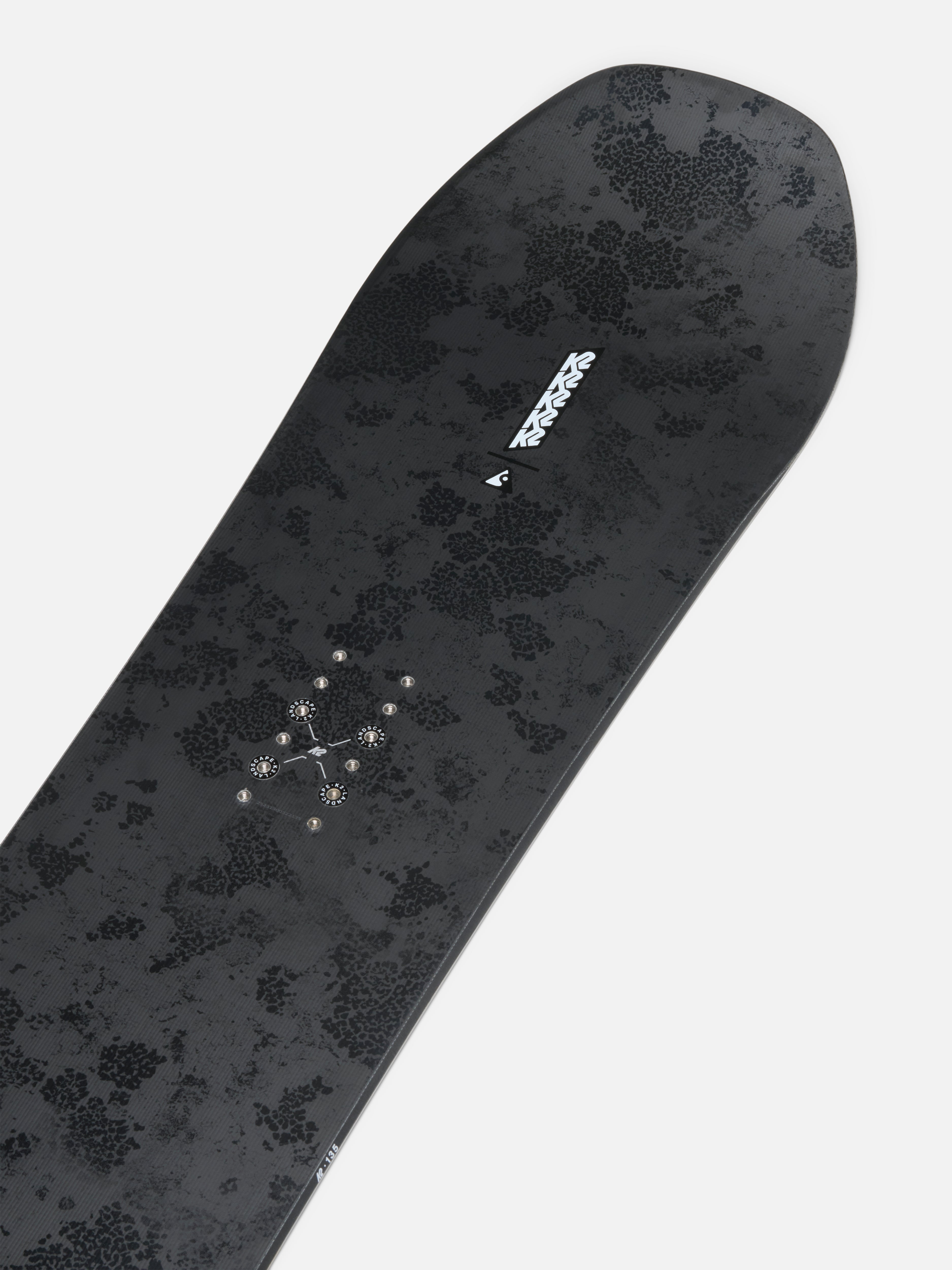 K2 Passport Jr snowboard showing the nose with bindings attached, designed for young riders, in a snow-covered outdoor setting.