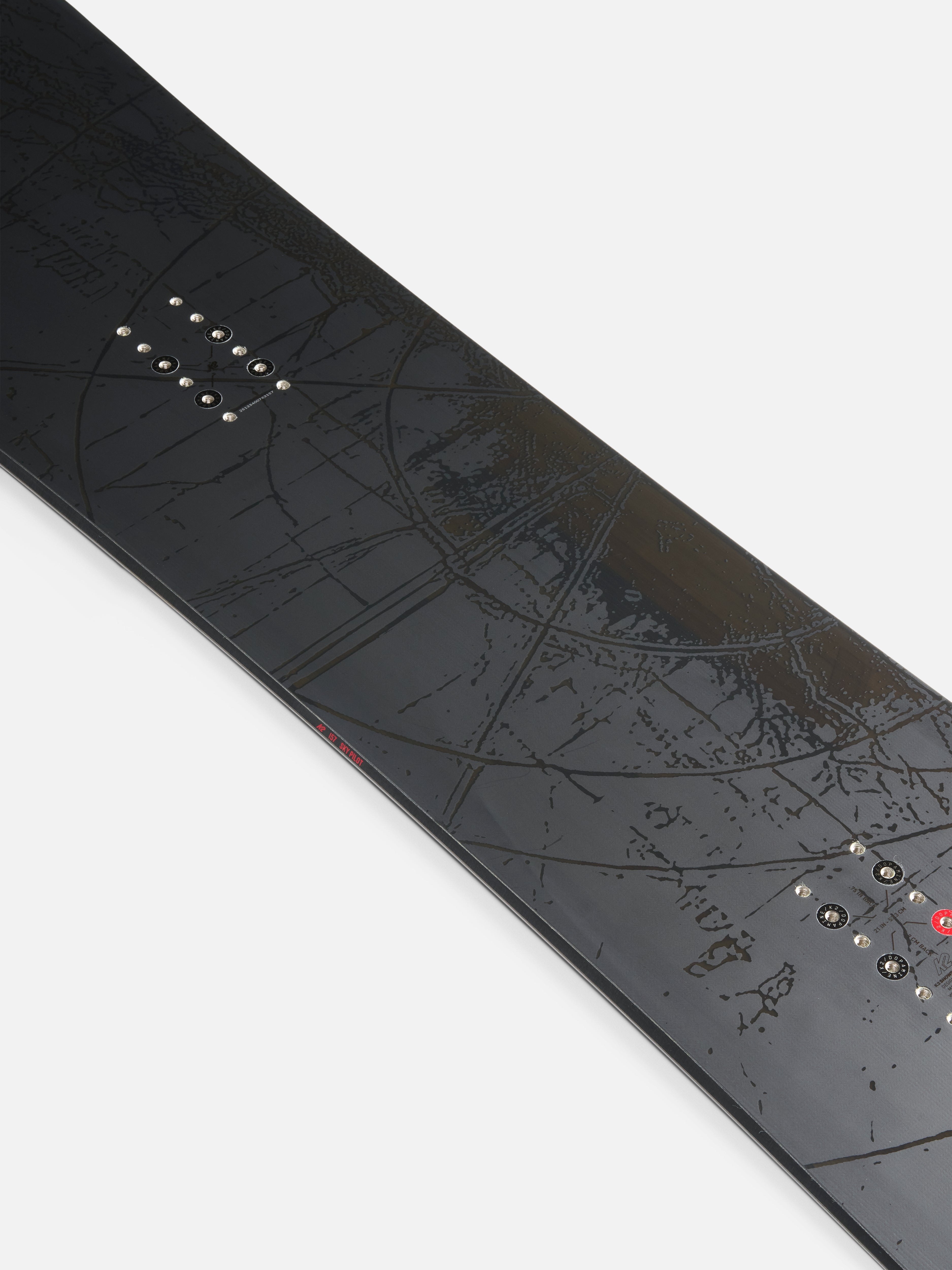 K2 Sky Pilot Snowboard 2027 with blue and black design, centered on the snow with mountain background.