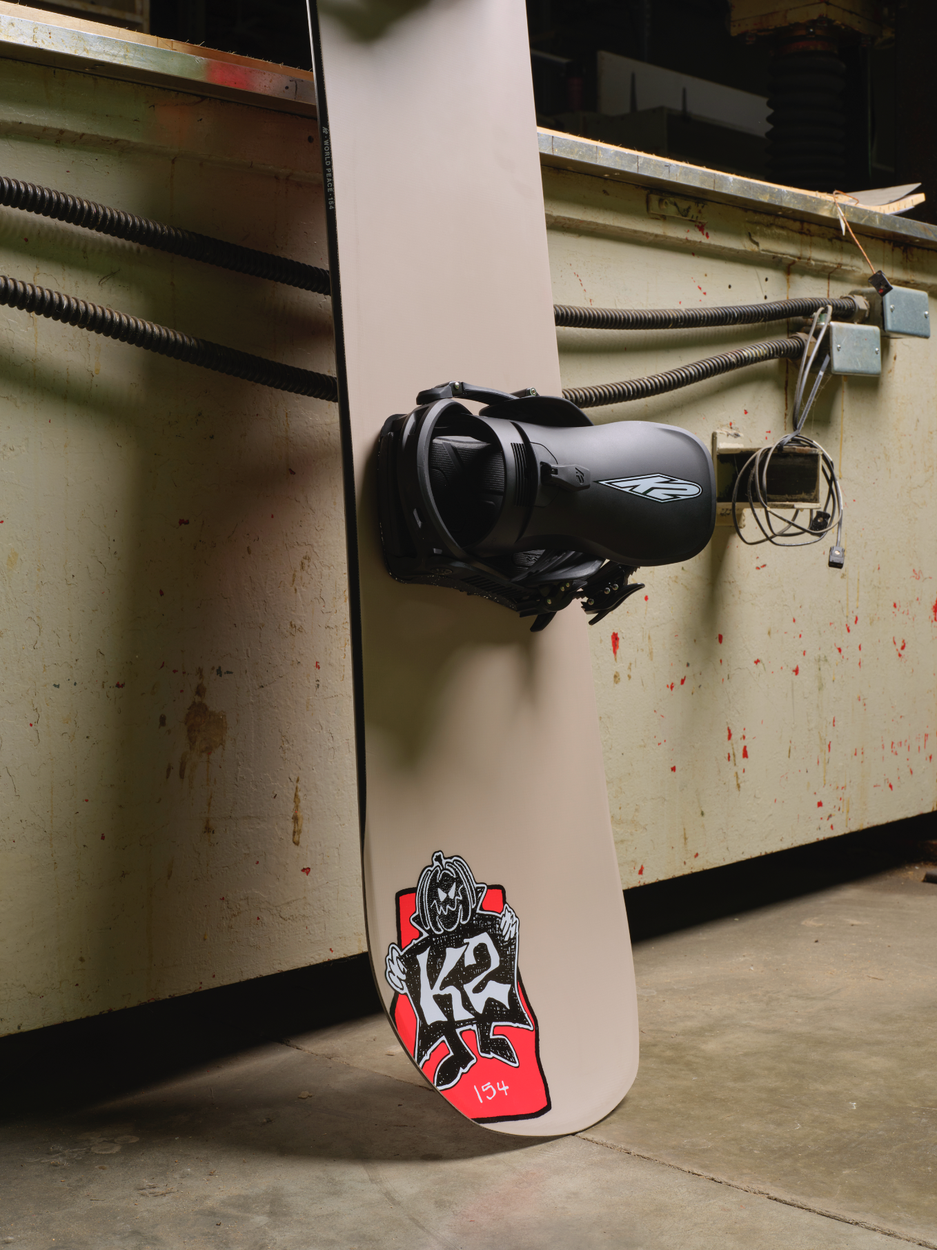 K2 World Peace snowboard 2027, side view showing the tail and graphics, designed for snowboarding enthusiasts.